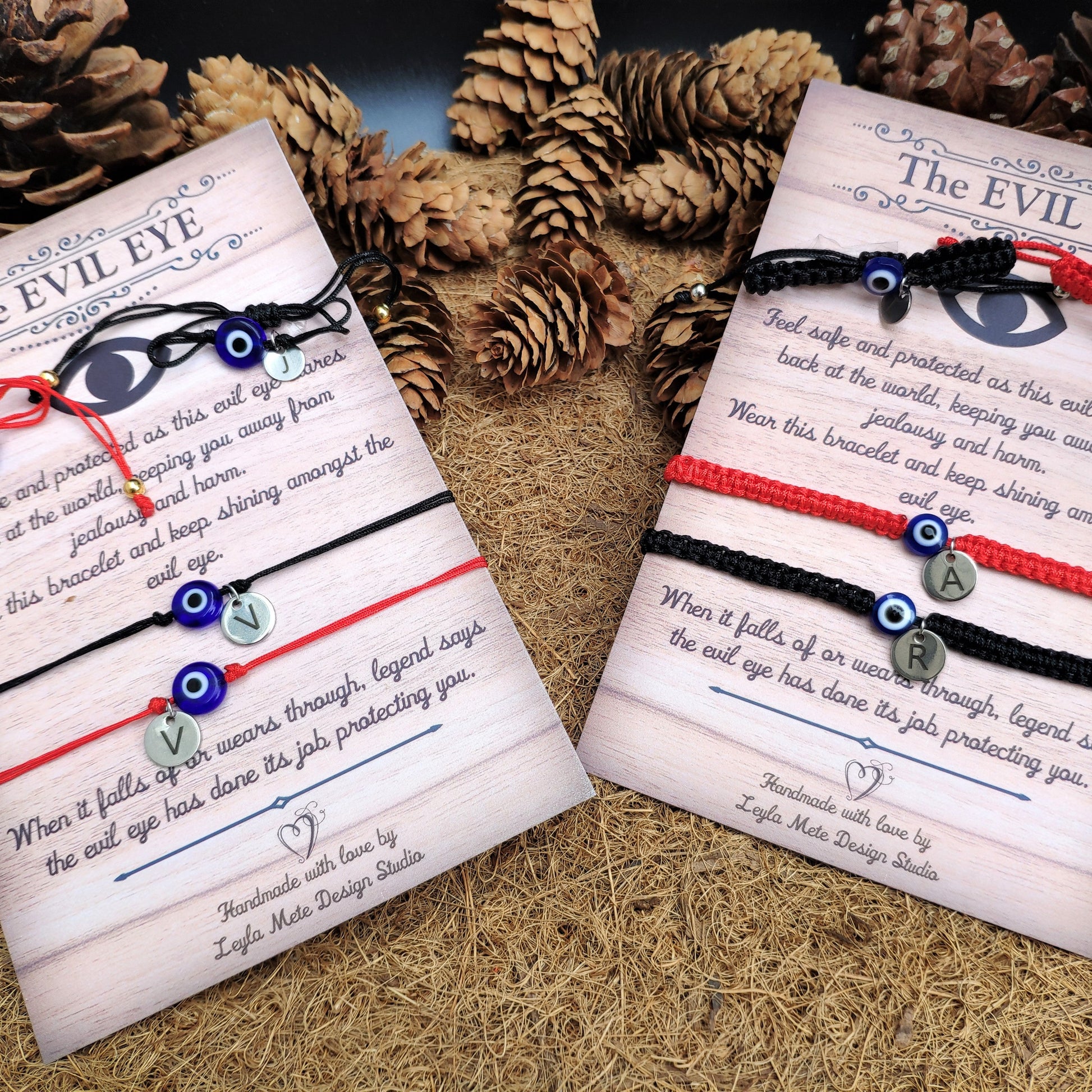 Two 'The Evil Eye' bracelets on cards with decorative background