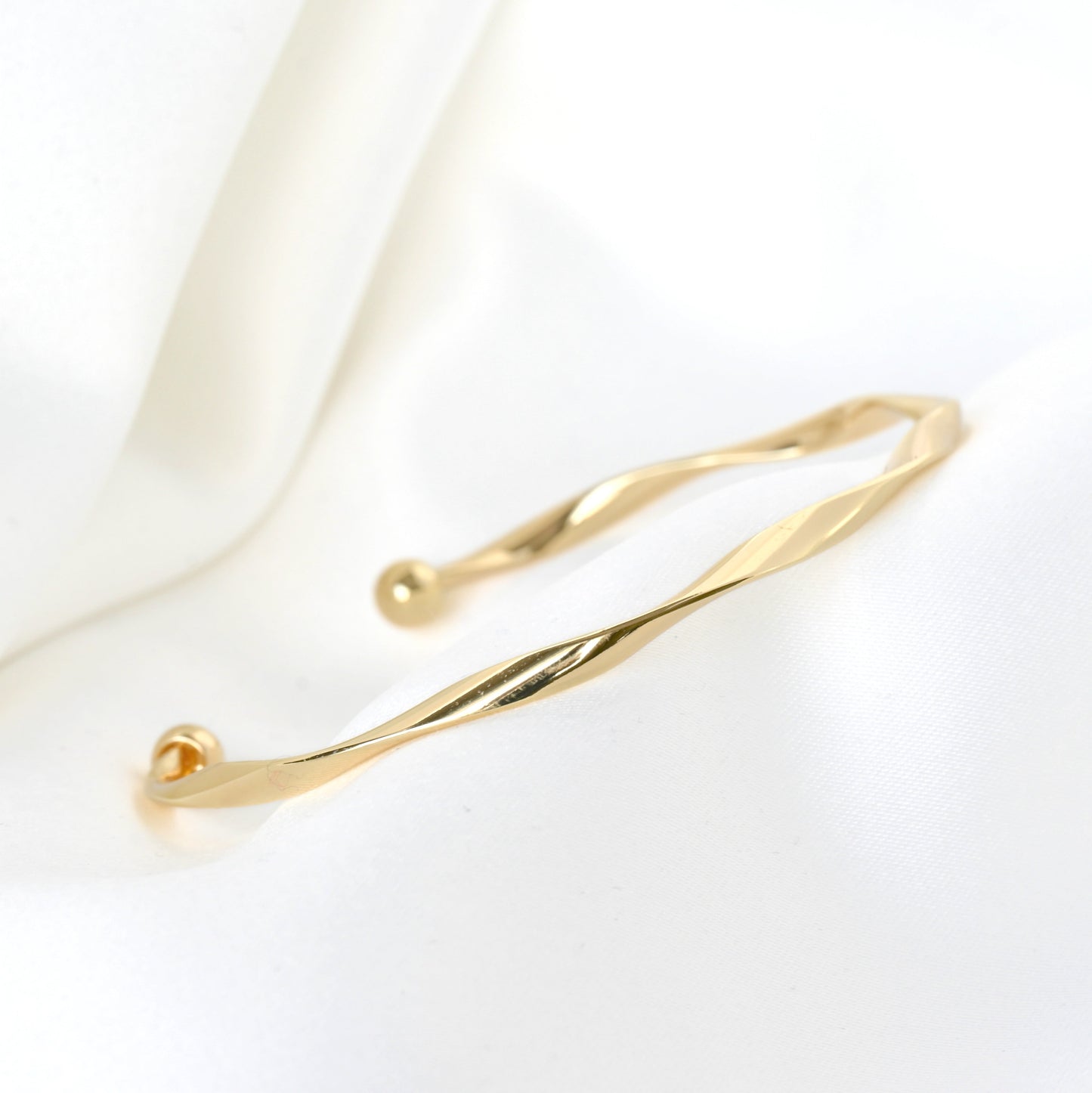 Gold bracelet on a white background
