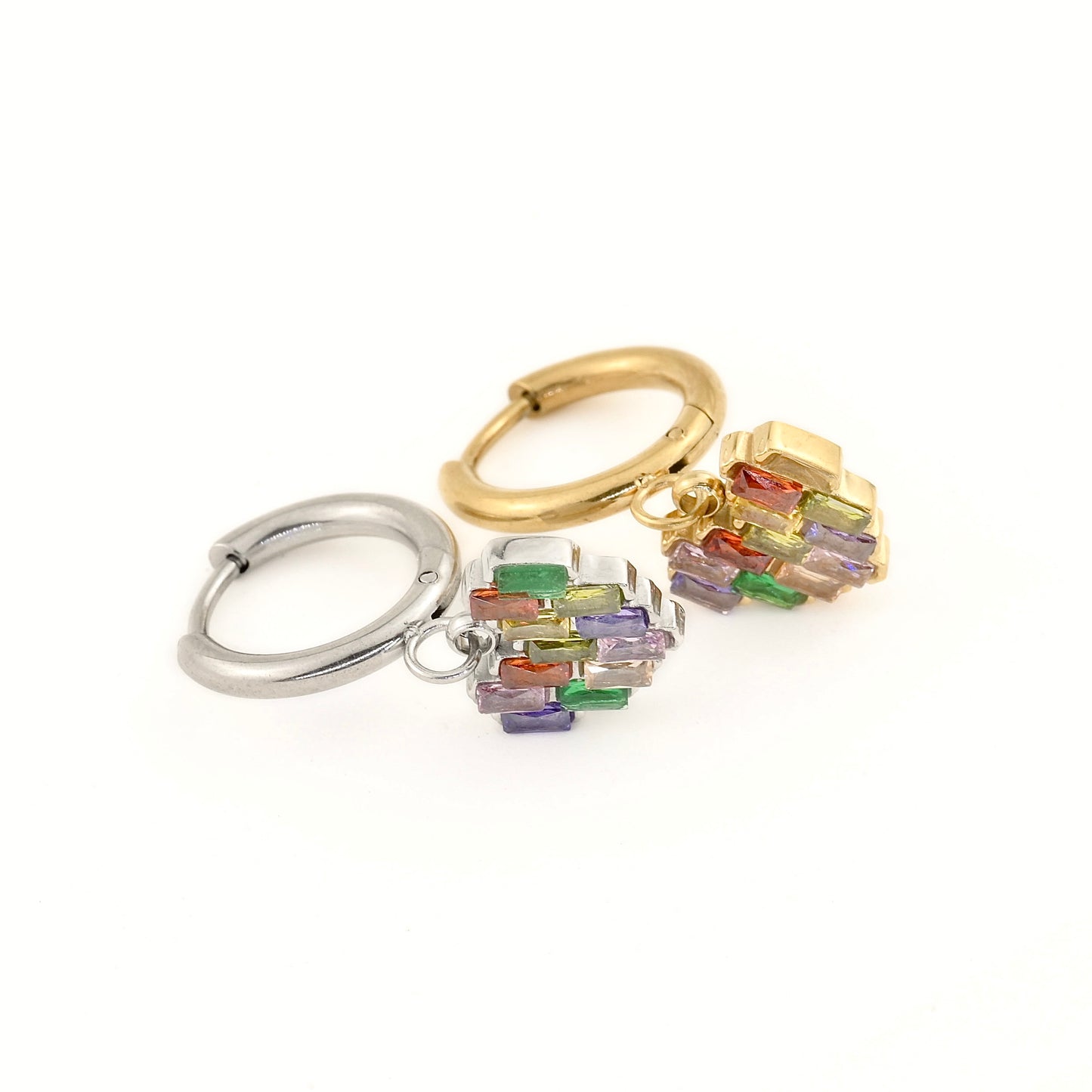 Gold and silver huggie earrings with a heart charm adorned with red, green, purple and yellow baguette-cut stones