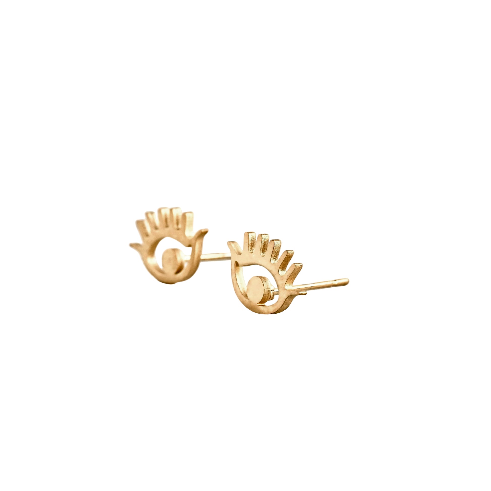 Gold eye with lashes stud earrings on a white background