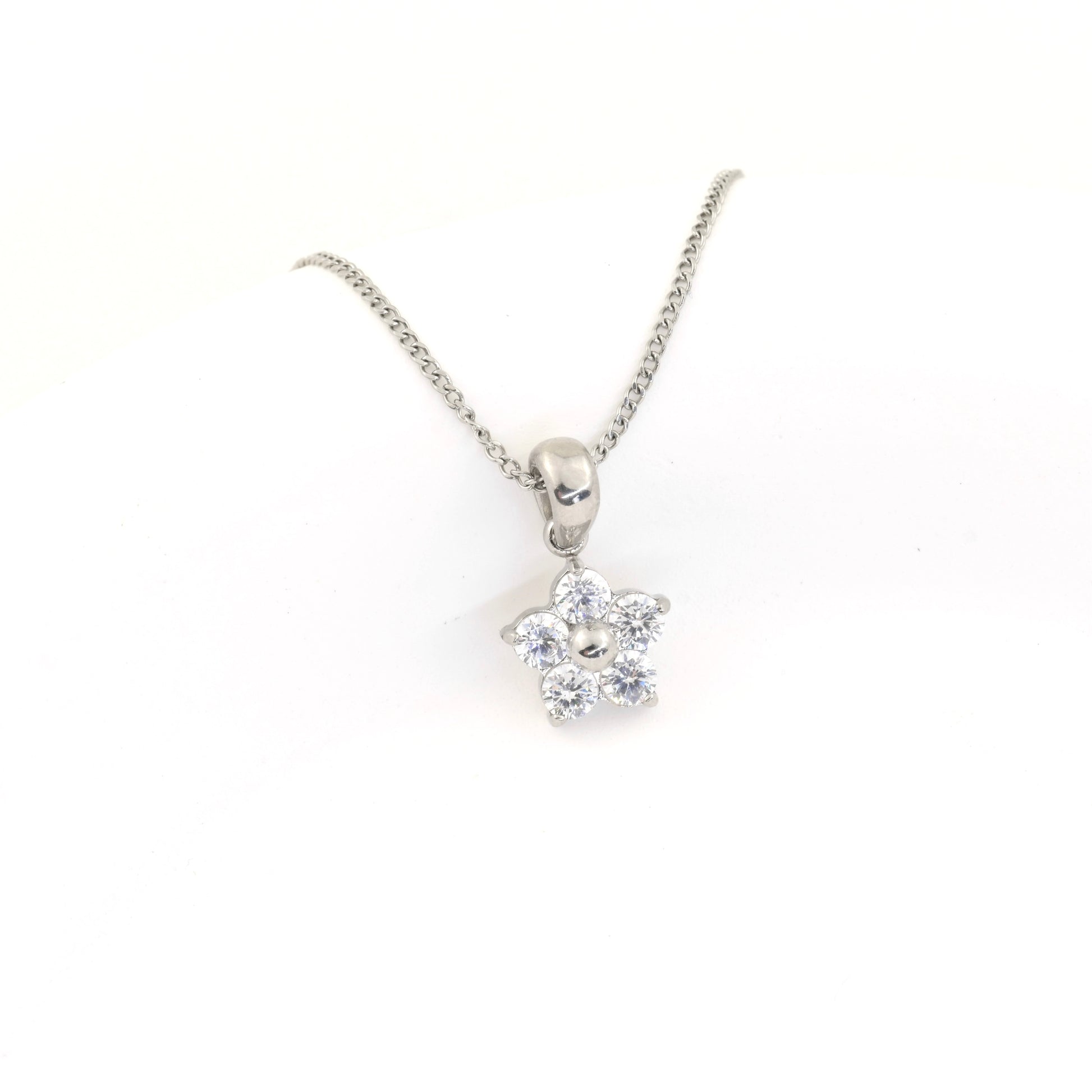 Silver necklace with a flower-shaped pendant on a white background