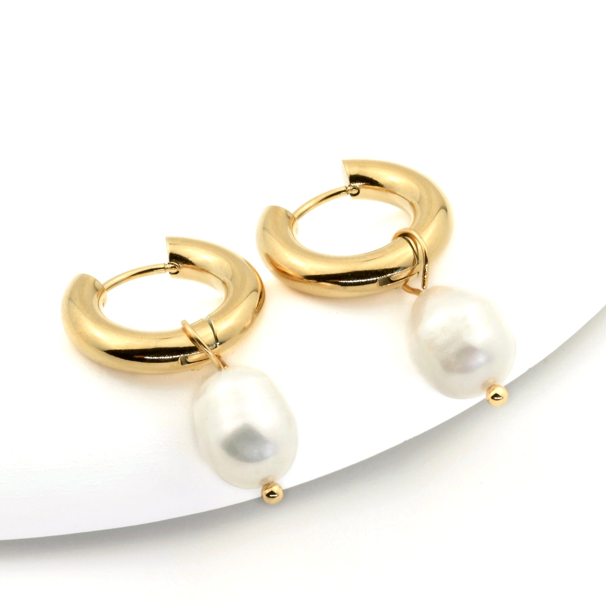 Chunky Gold hoop earrings with pearls on a white background