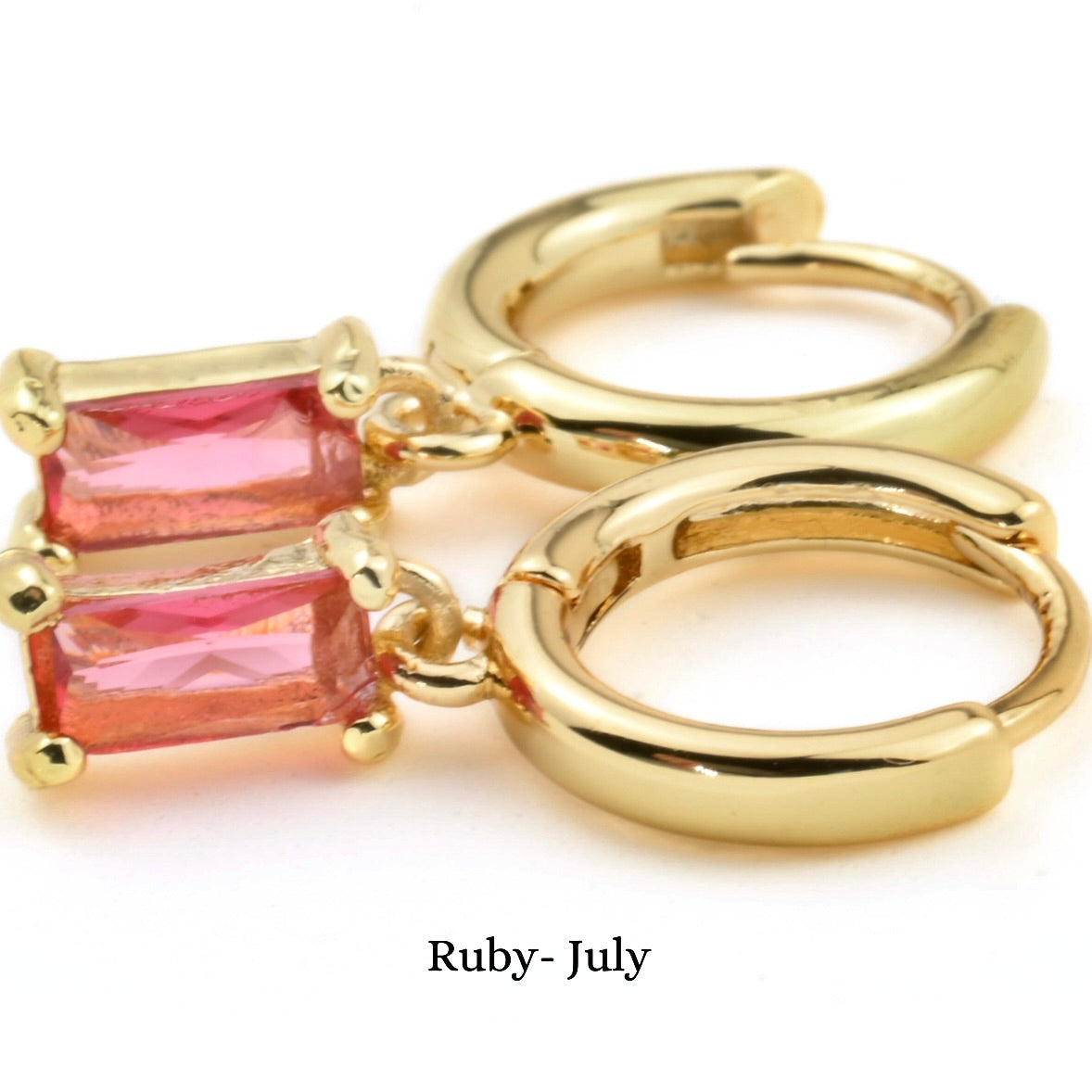 Gold hoop earrings with july 'ruby' stone on a white background