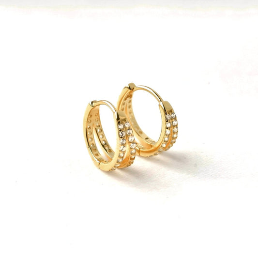 Gold spit hoop earrings with embedded stones on a white background