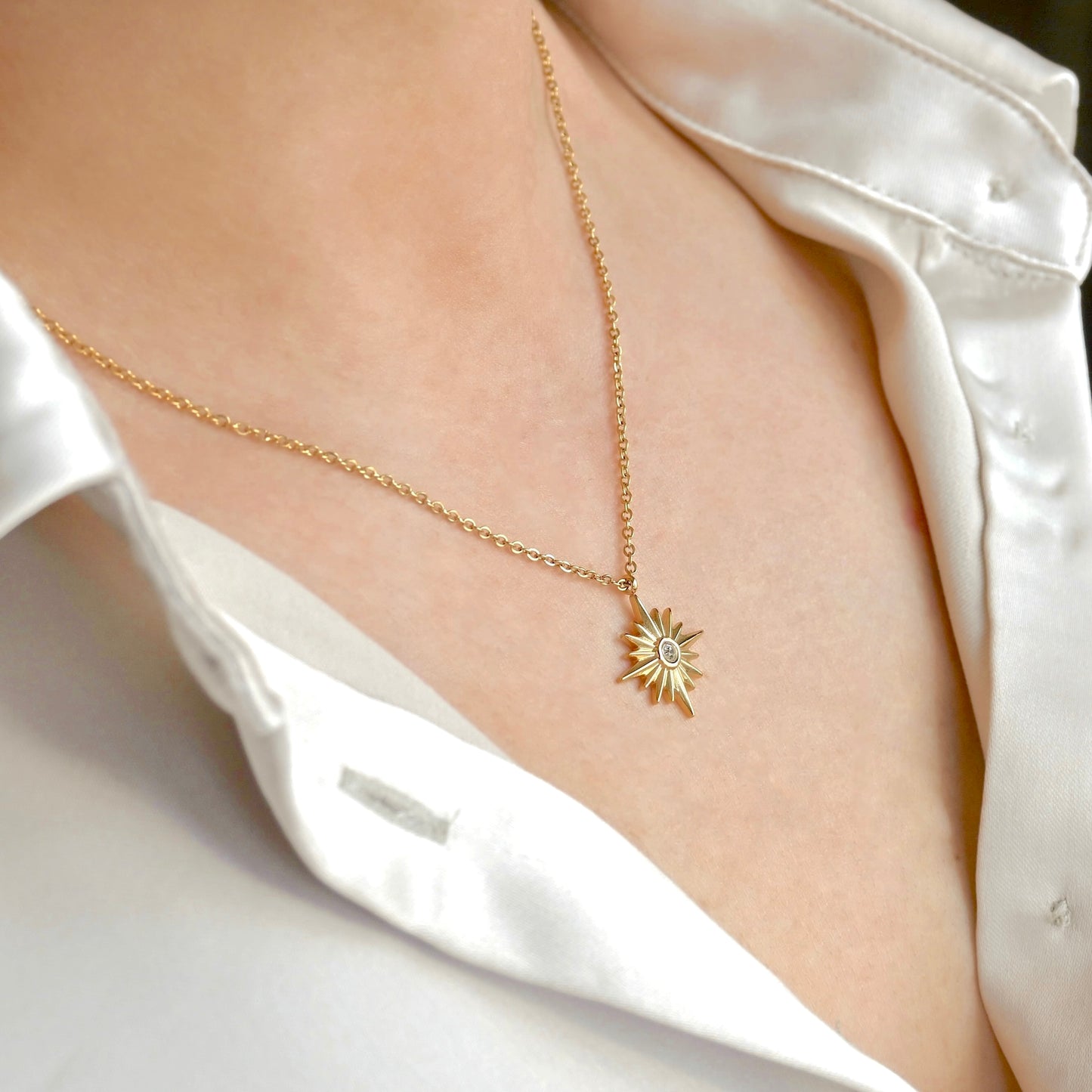 Side view of gold star medallion on a person wearing a white shirt