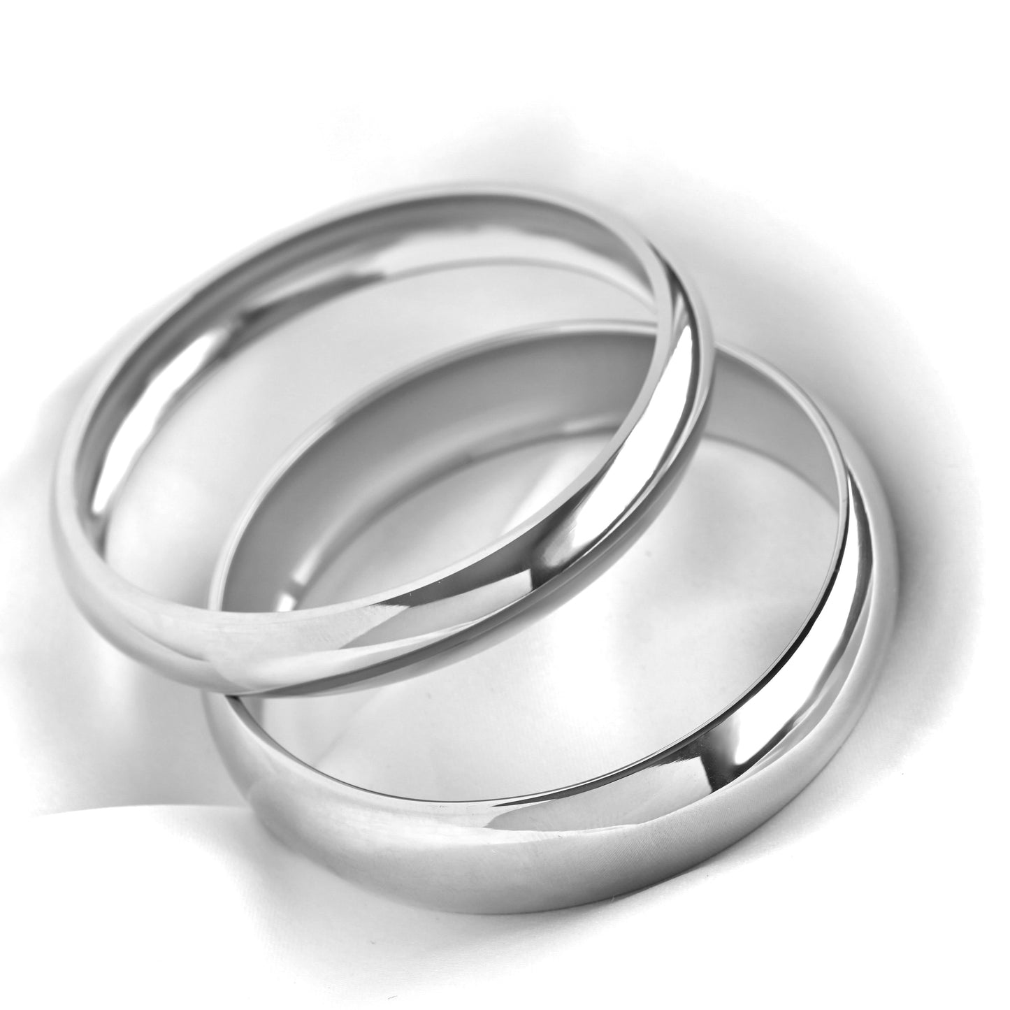 Two high-polish silver dome bangles stacked together on a white background.