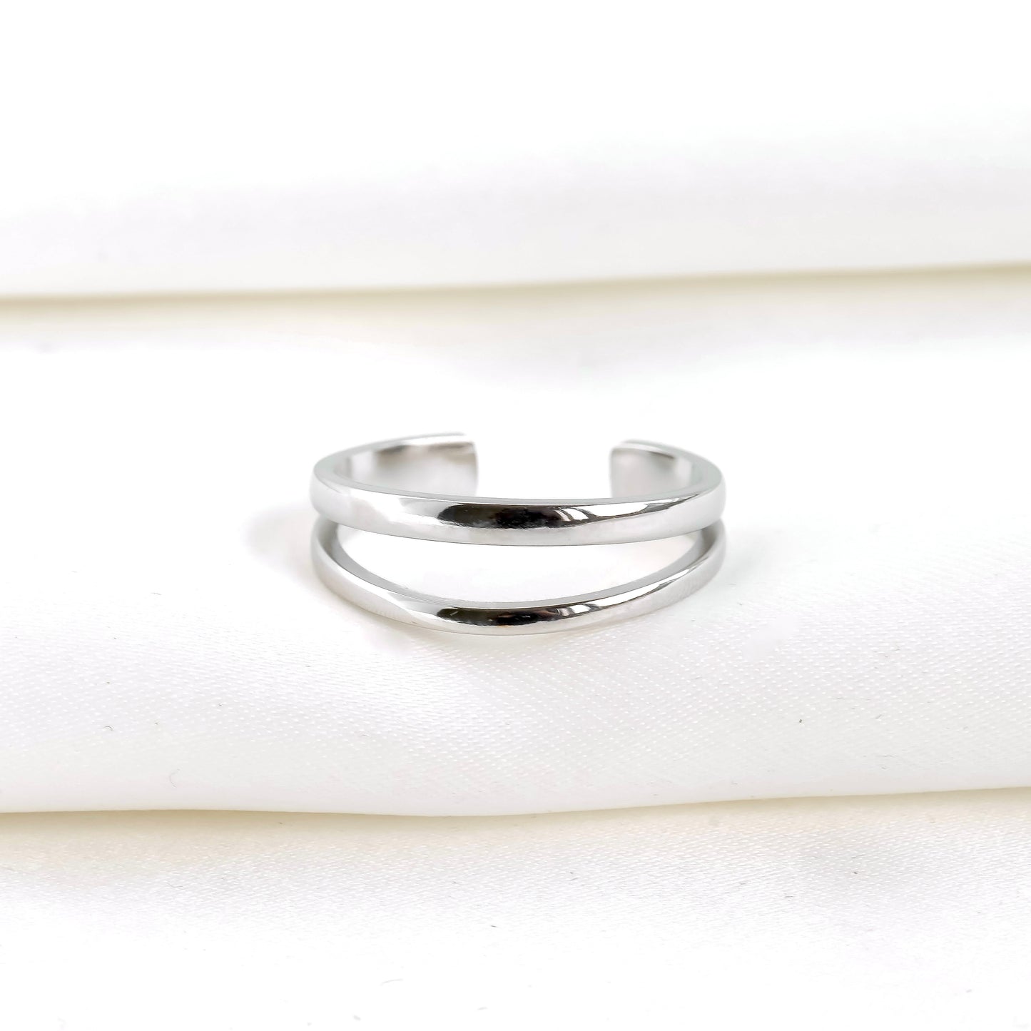 front view of layered silver cuff ring on a white background