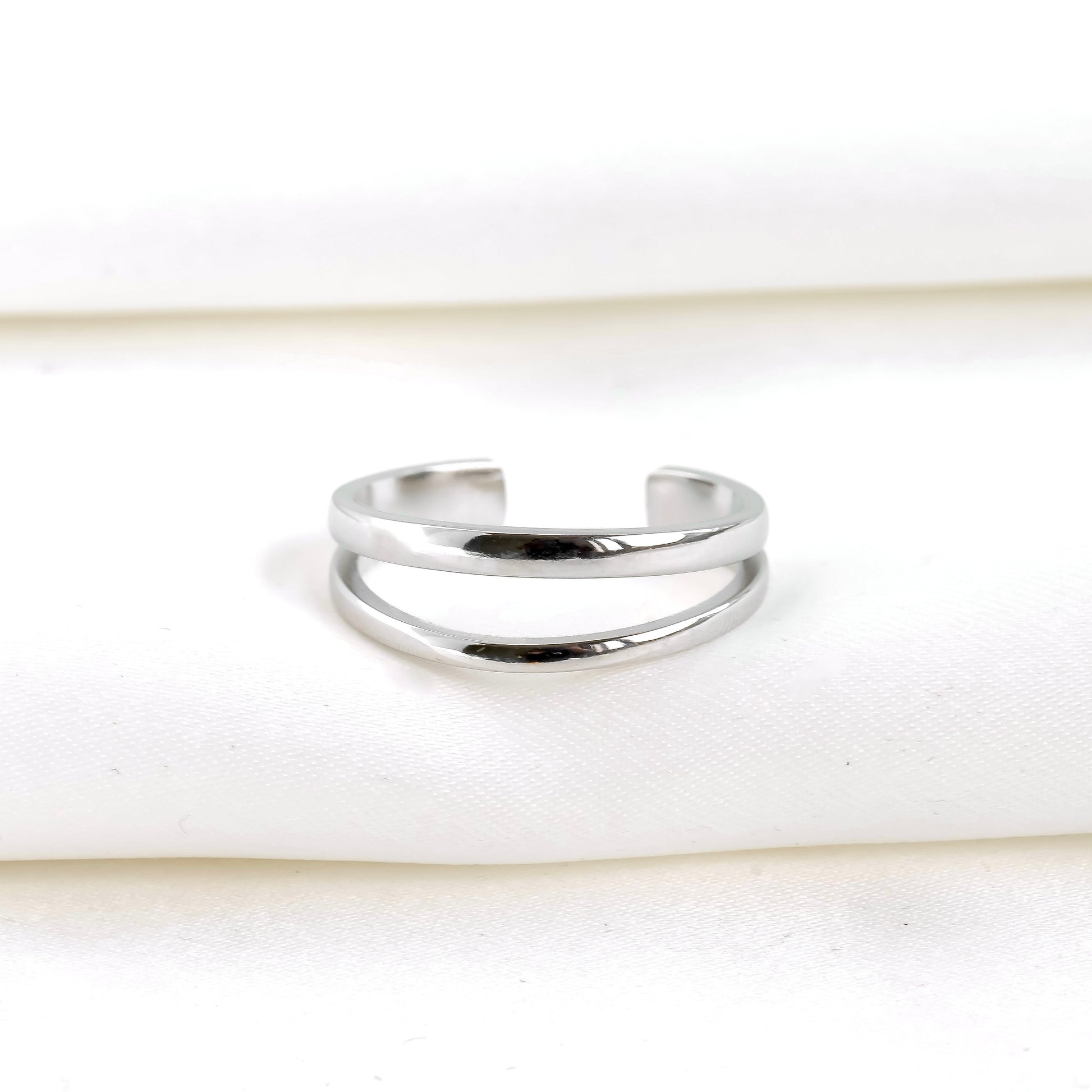 front view of layered silver cuff ring on a white background