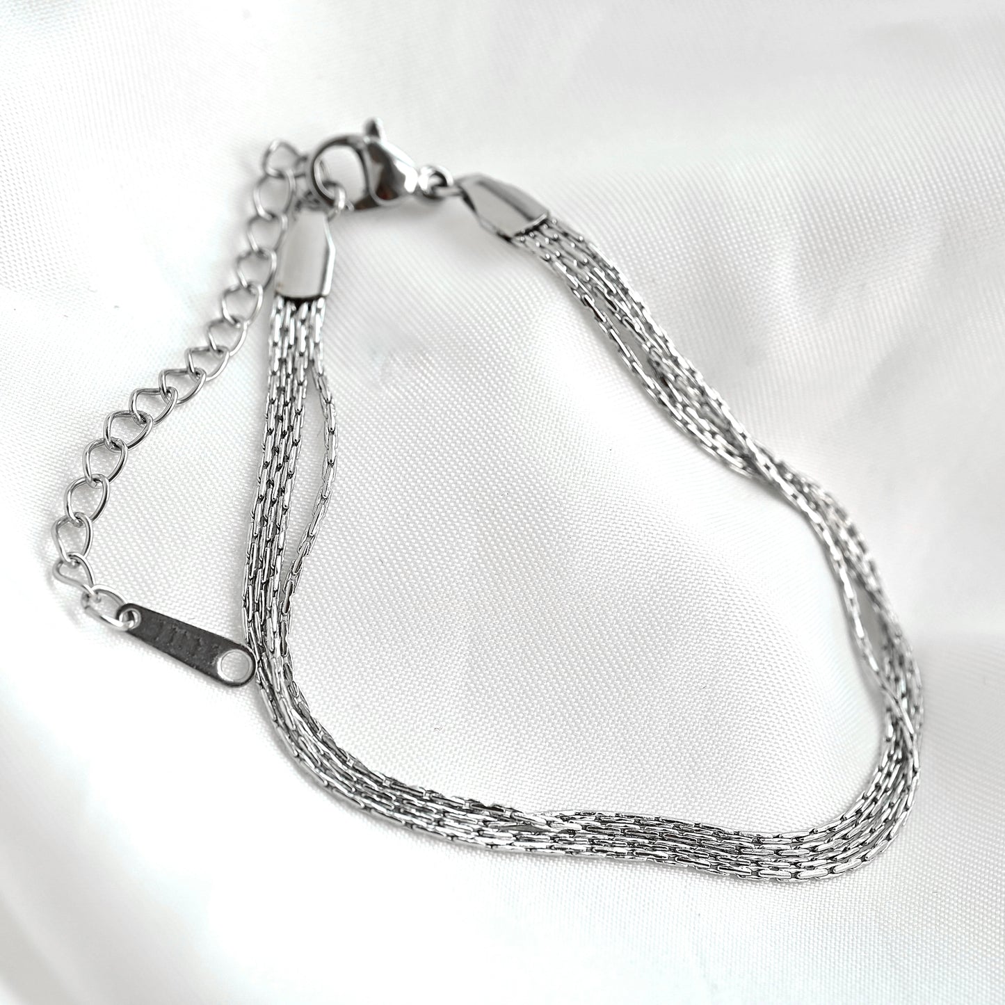 Silver chain bracelet on a white background