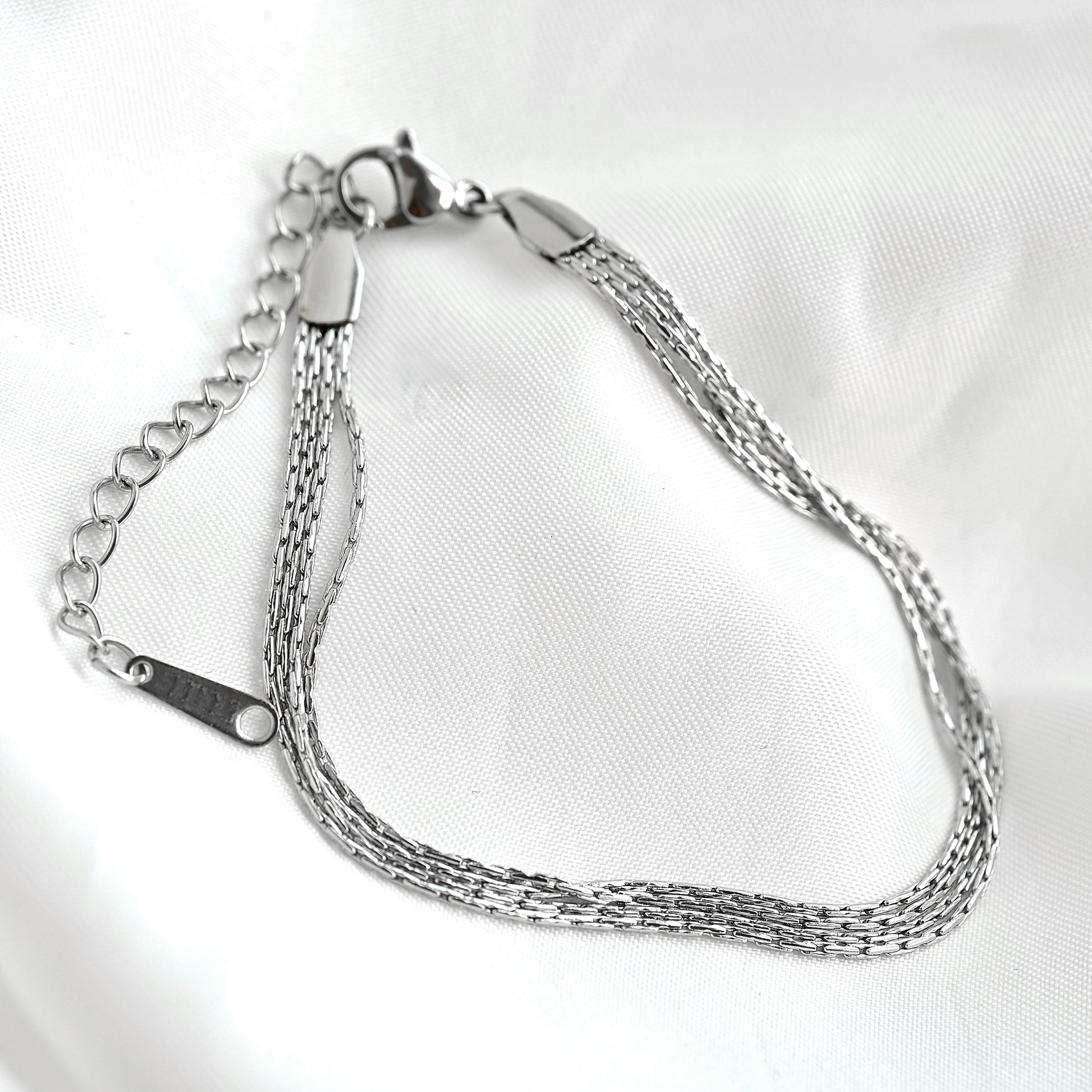 Silver chain bracelet on a white background