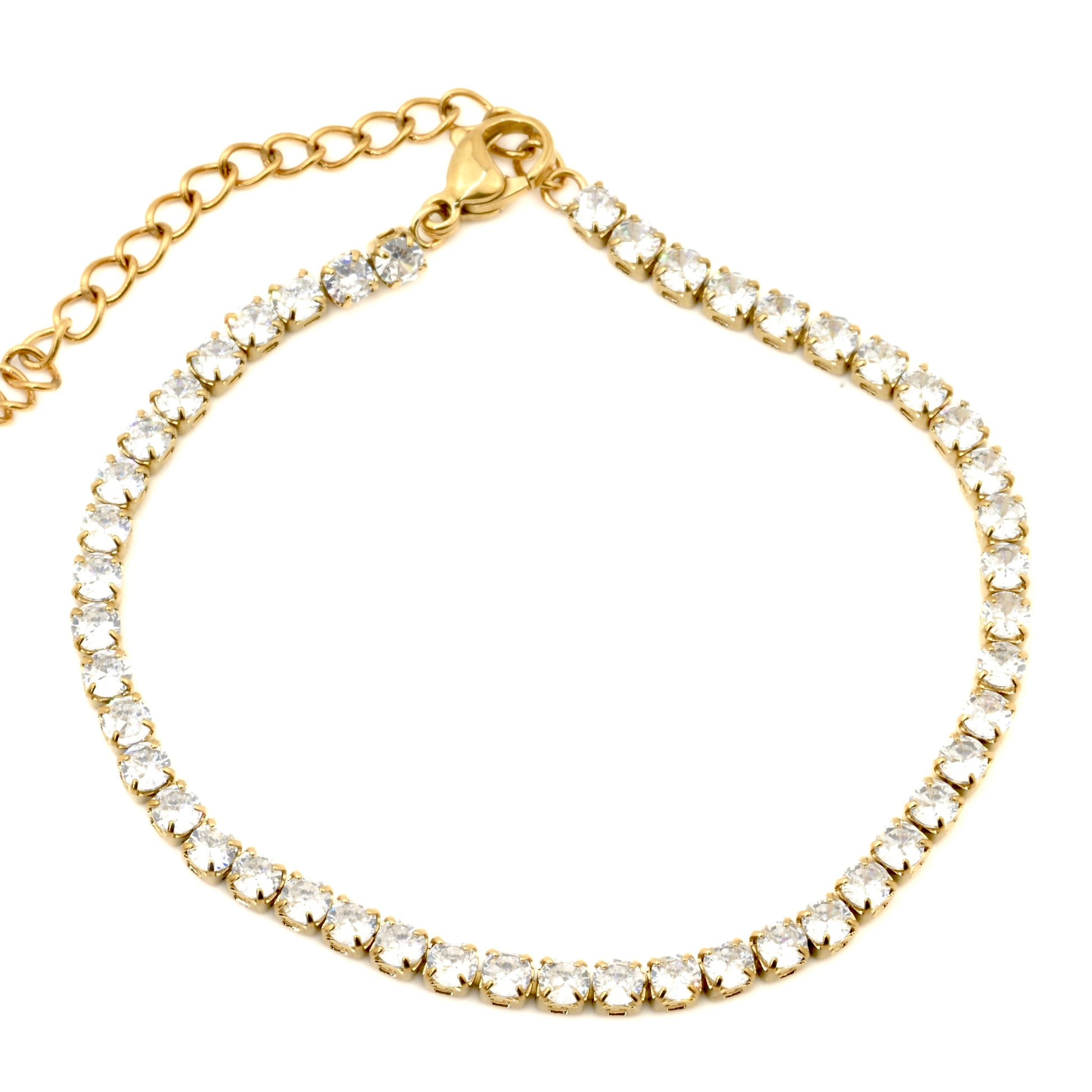Top view of gold tennis chain bracelet with clear cubic zirconia on a white background