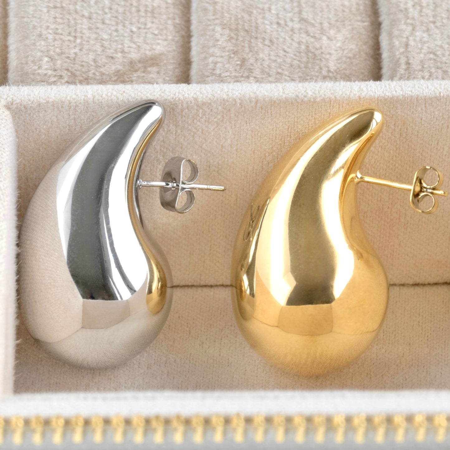 Gold and silver chunky hollow drop earrings in a jewelry case