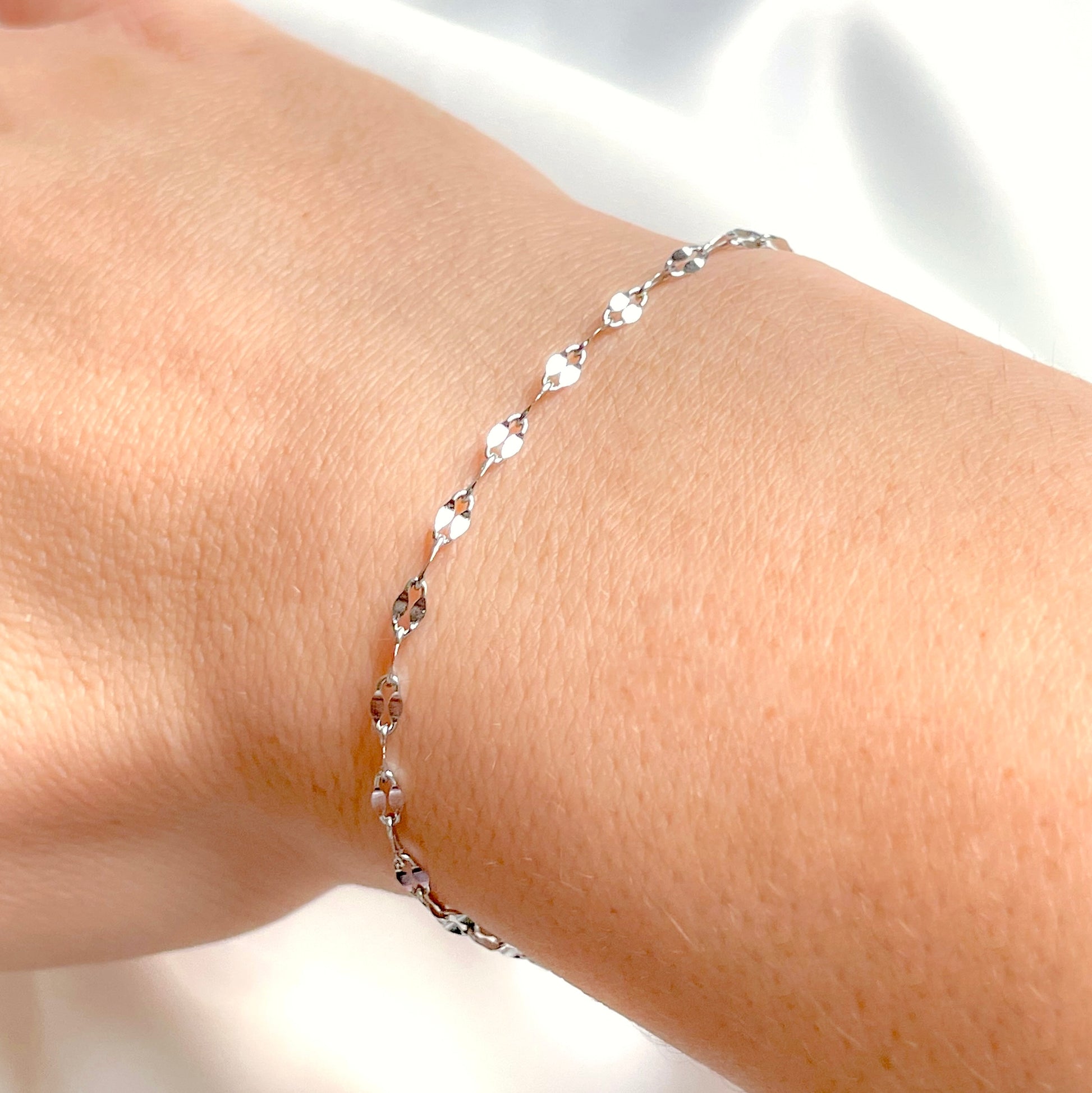 Sparkling silver bracelet on a wrist with a blurred background