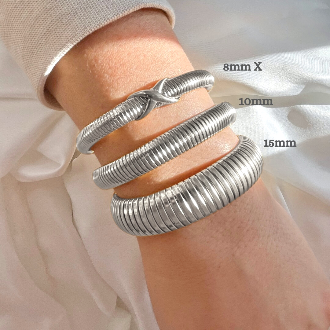 Three silver tubogas bracelets, from oversized to dainty with an X knot on a wrist with size measurements