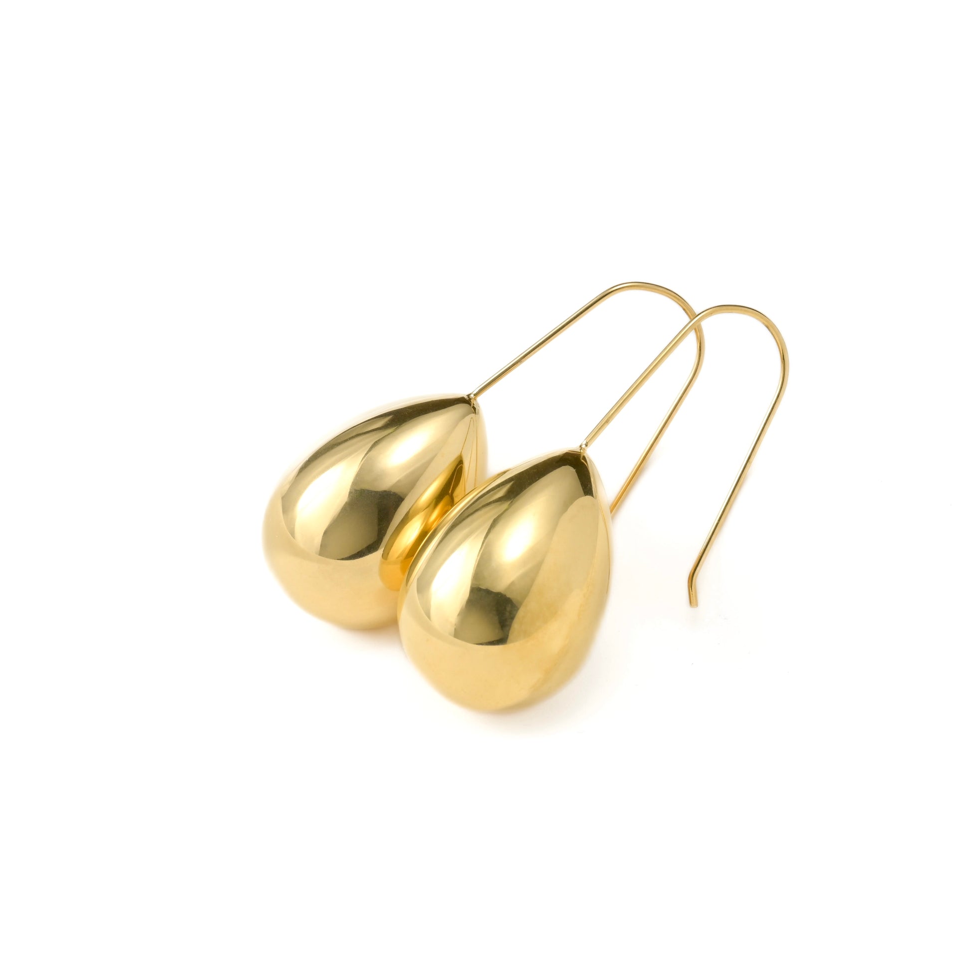 Angled view of 18k gold teardrop earrings on a white background