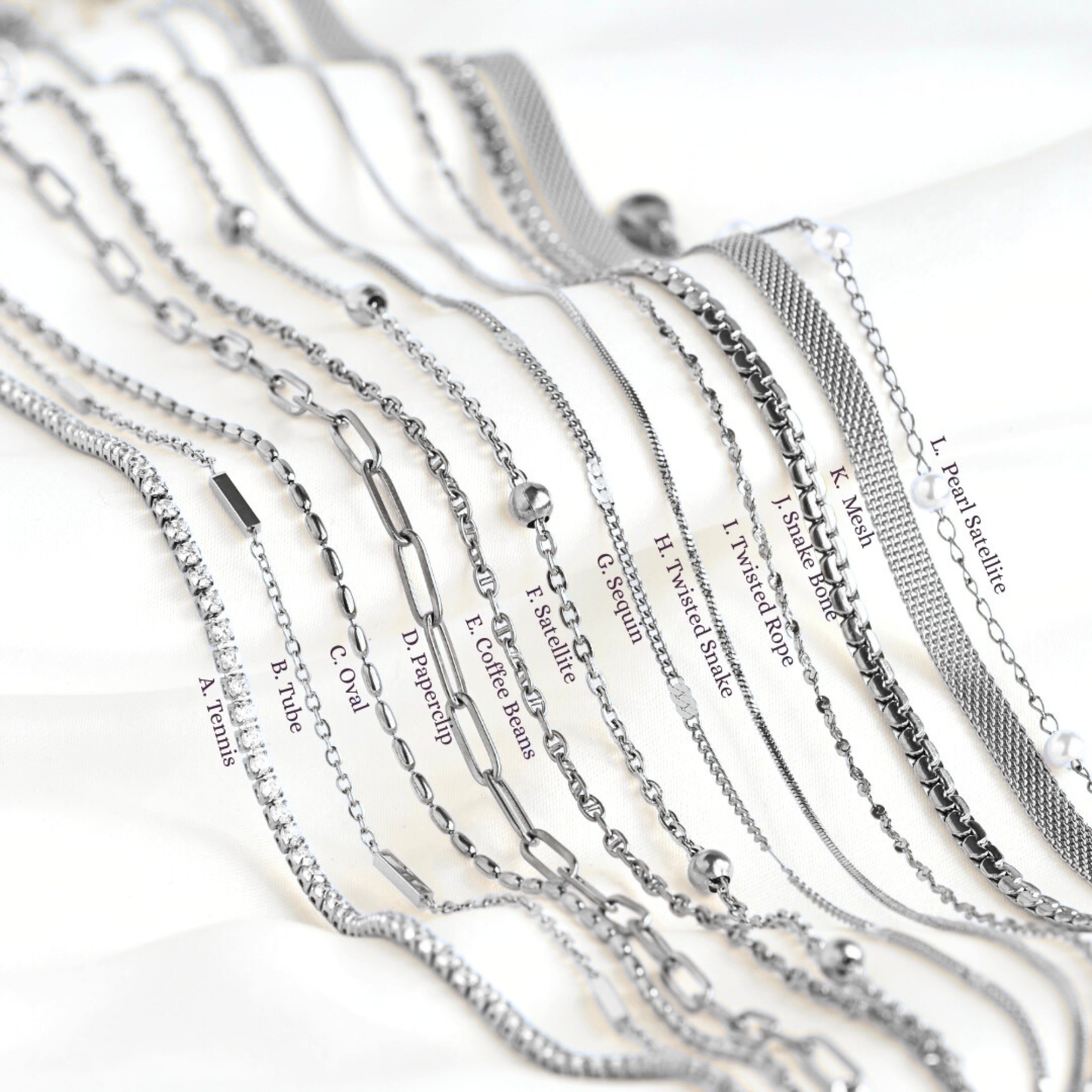 Collection of silver necklaces with various designs on a white background