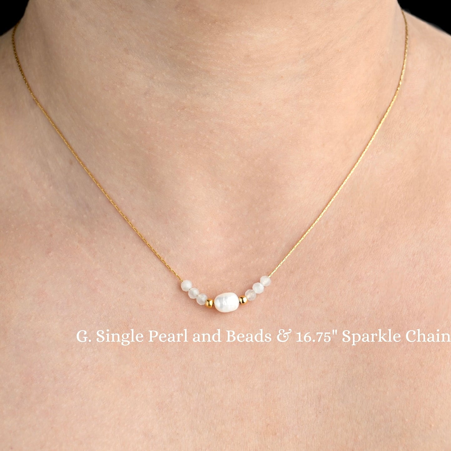 Gold necklace with pearls  and white and gold beads on a person's neck against a neutral background