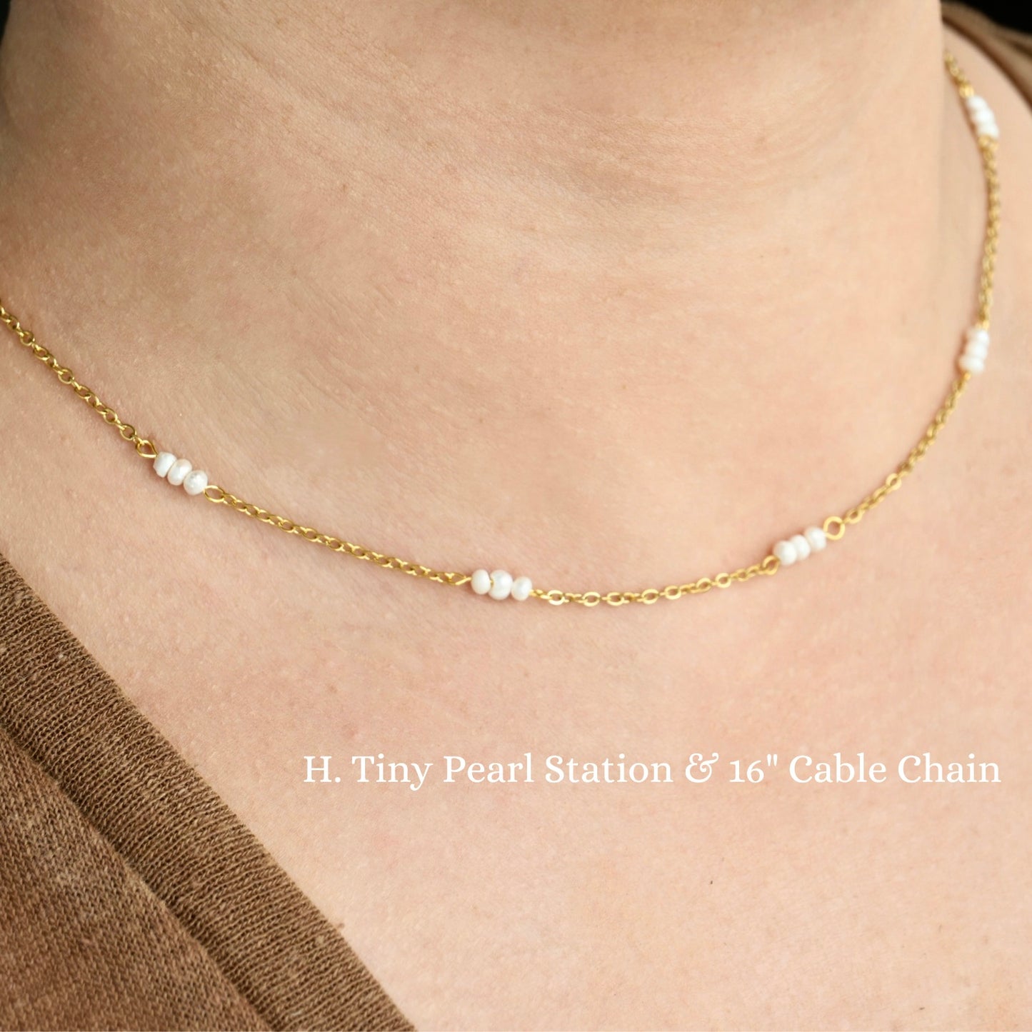 Gold necklace with tiny three pearl  cluster stations on a person's neck