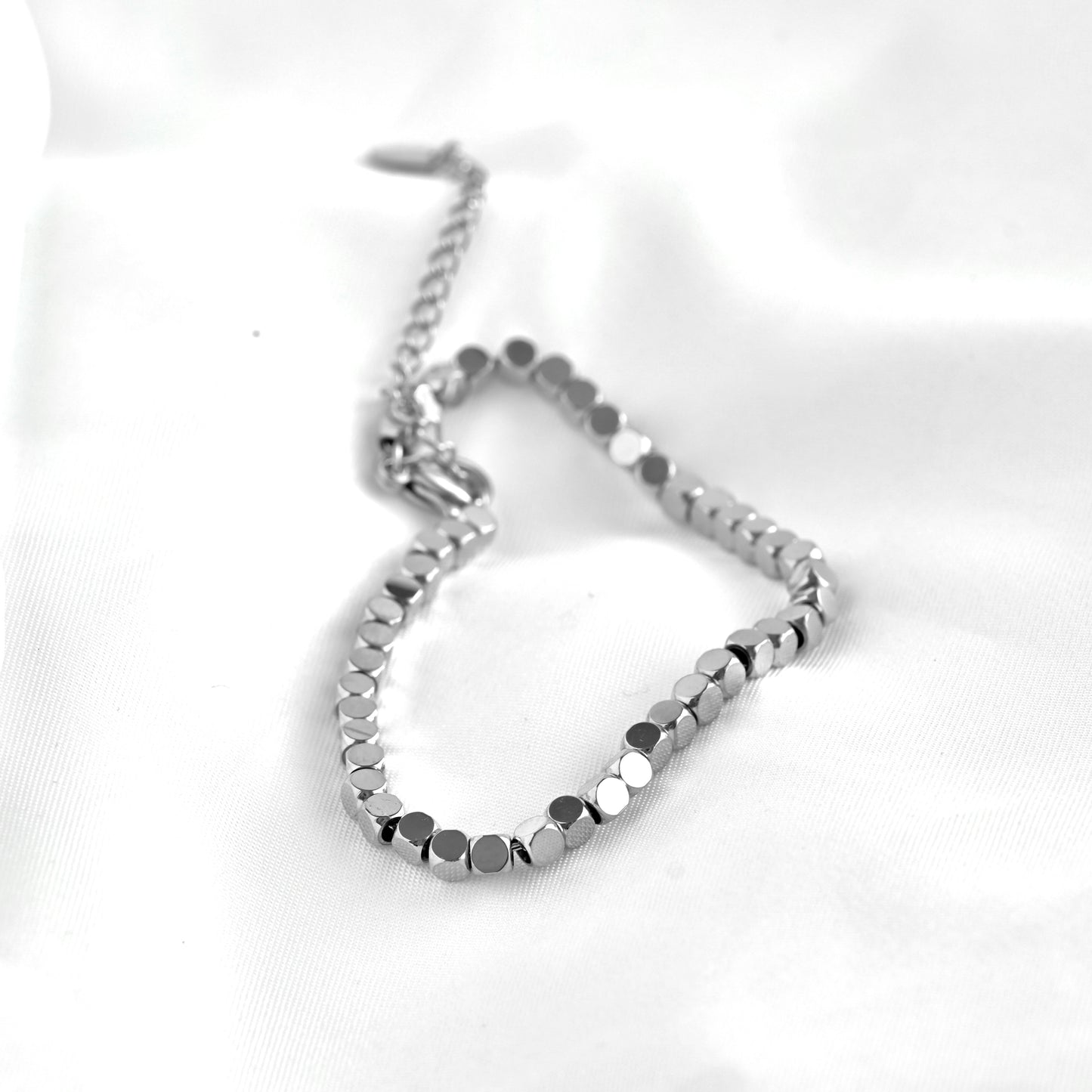 Silver square beaded bracelet on a white background