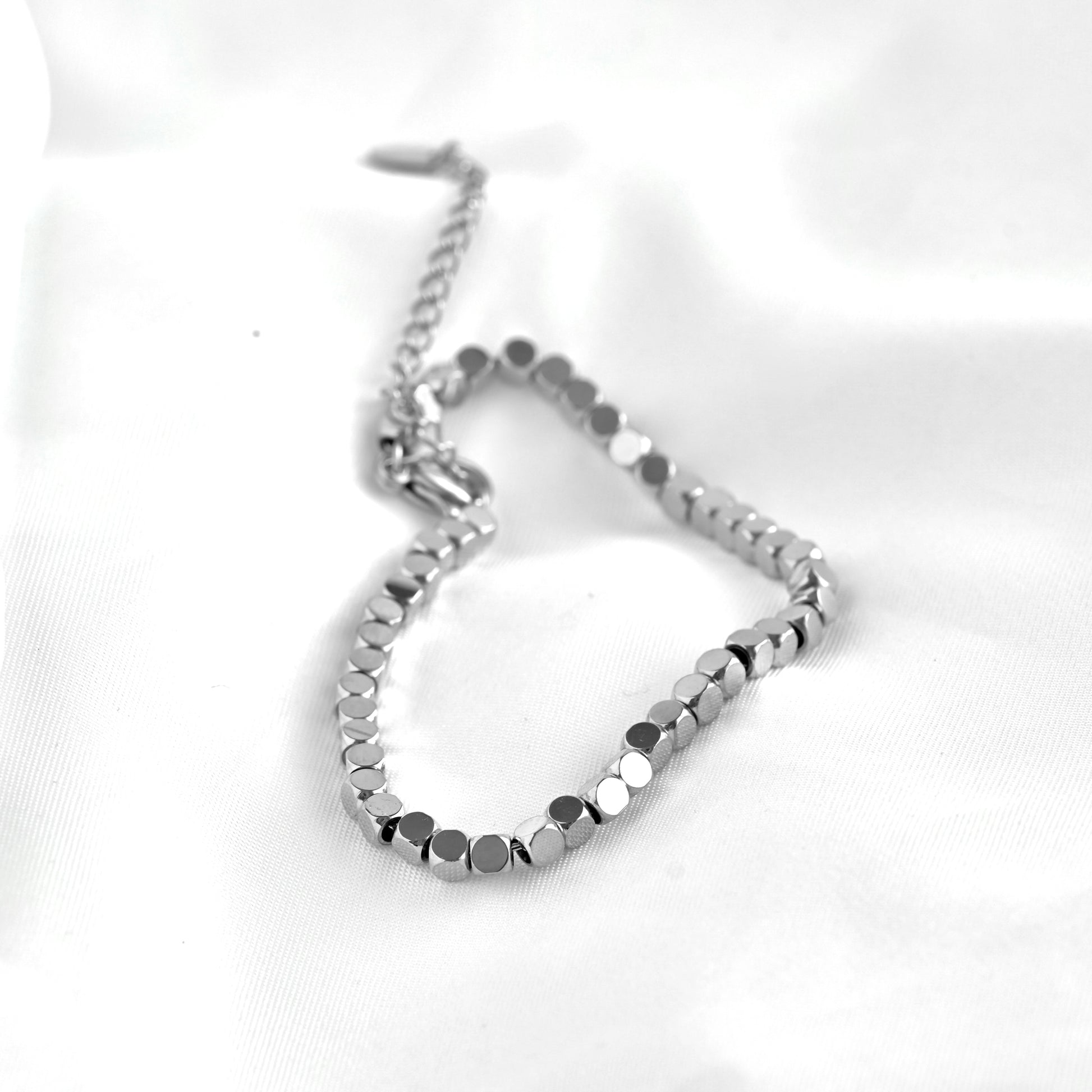 Silver square beaded bracelet on a white background