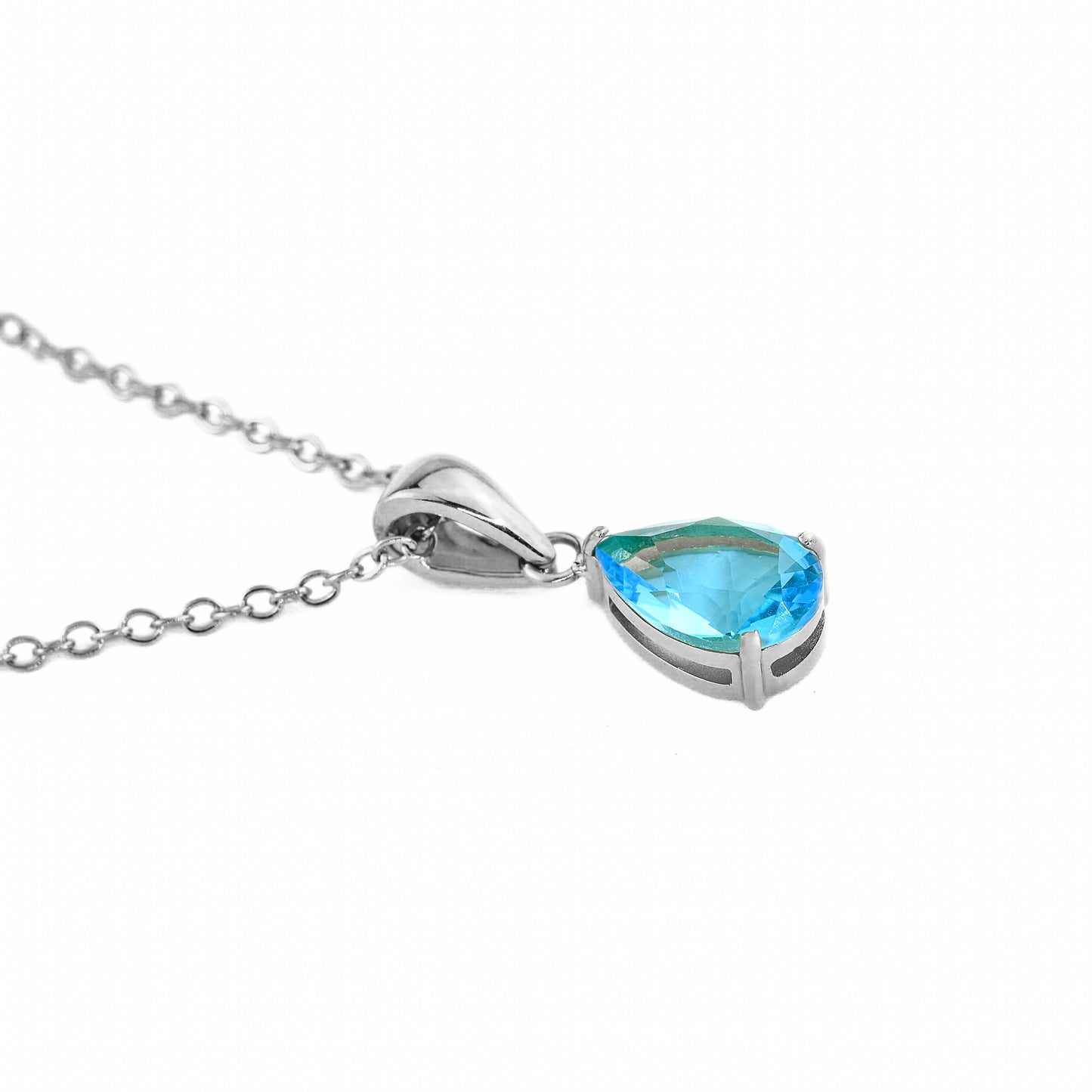 silver necklace with pear cut december birthstone 'turquoise' on a white background