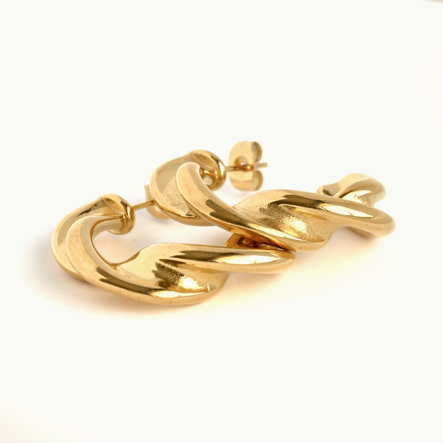 Thick twisted hoops stacked on a white background