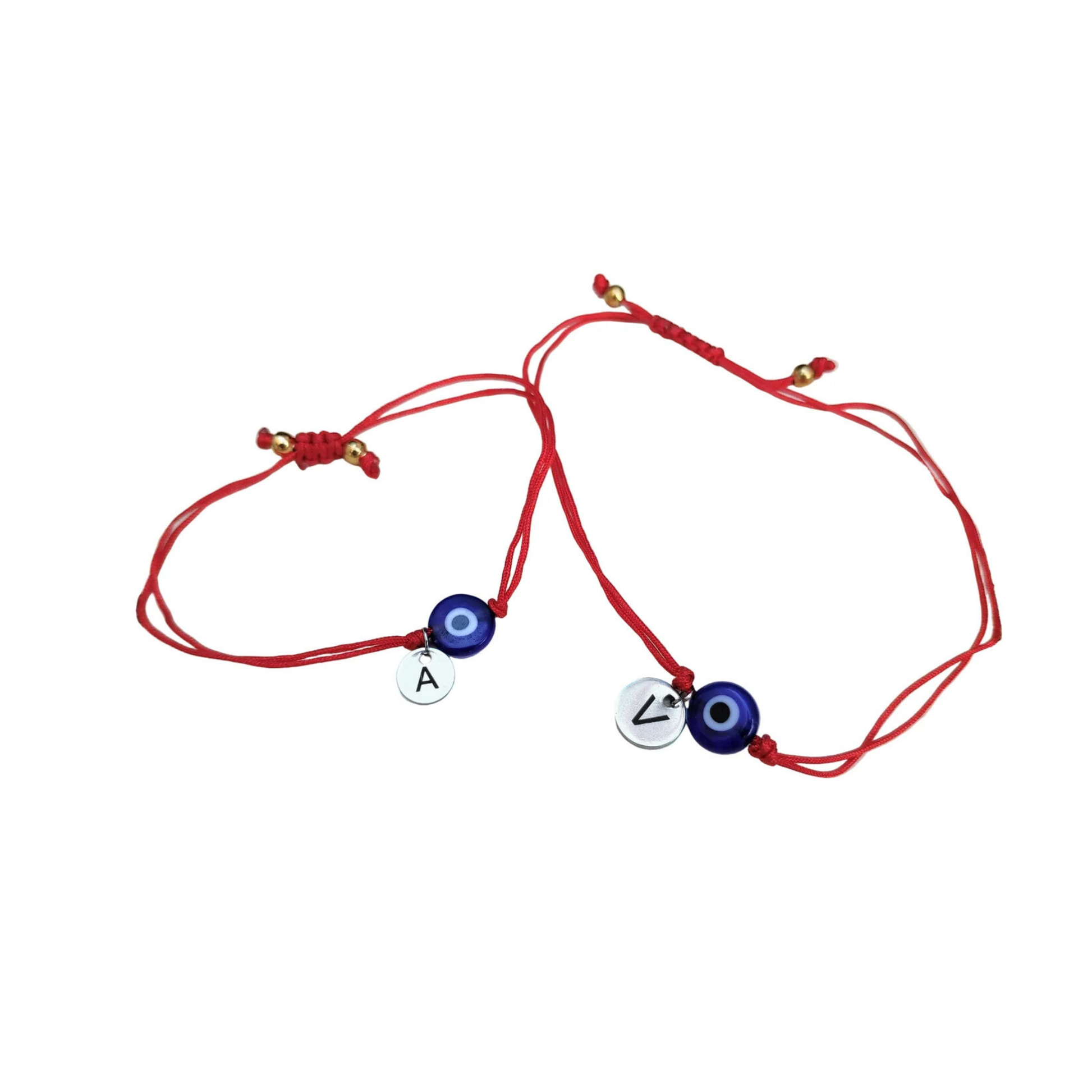 Two personalized friendship bracelets with evil eye charms and initials on a white background