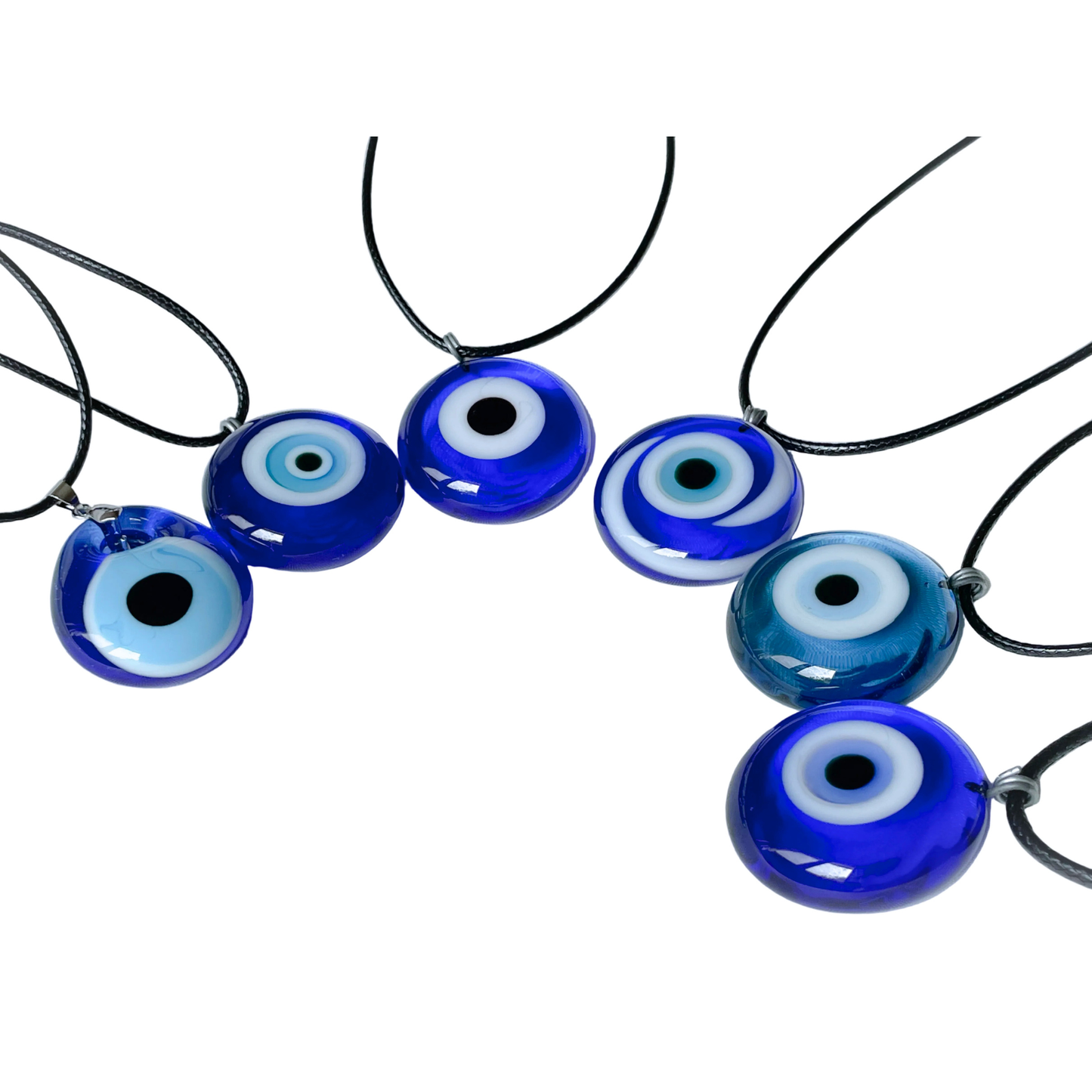 Blue glass evil eye medallions of various designs and shapes on a white background