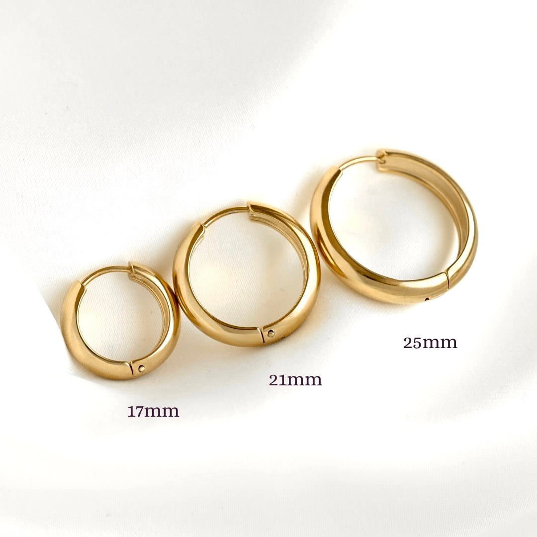 Three gold hoop earrings in 17mm, 21mm, and 25mm sizes arranged diagonally on a white background with size labels.