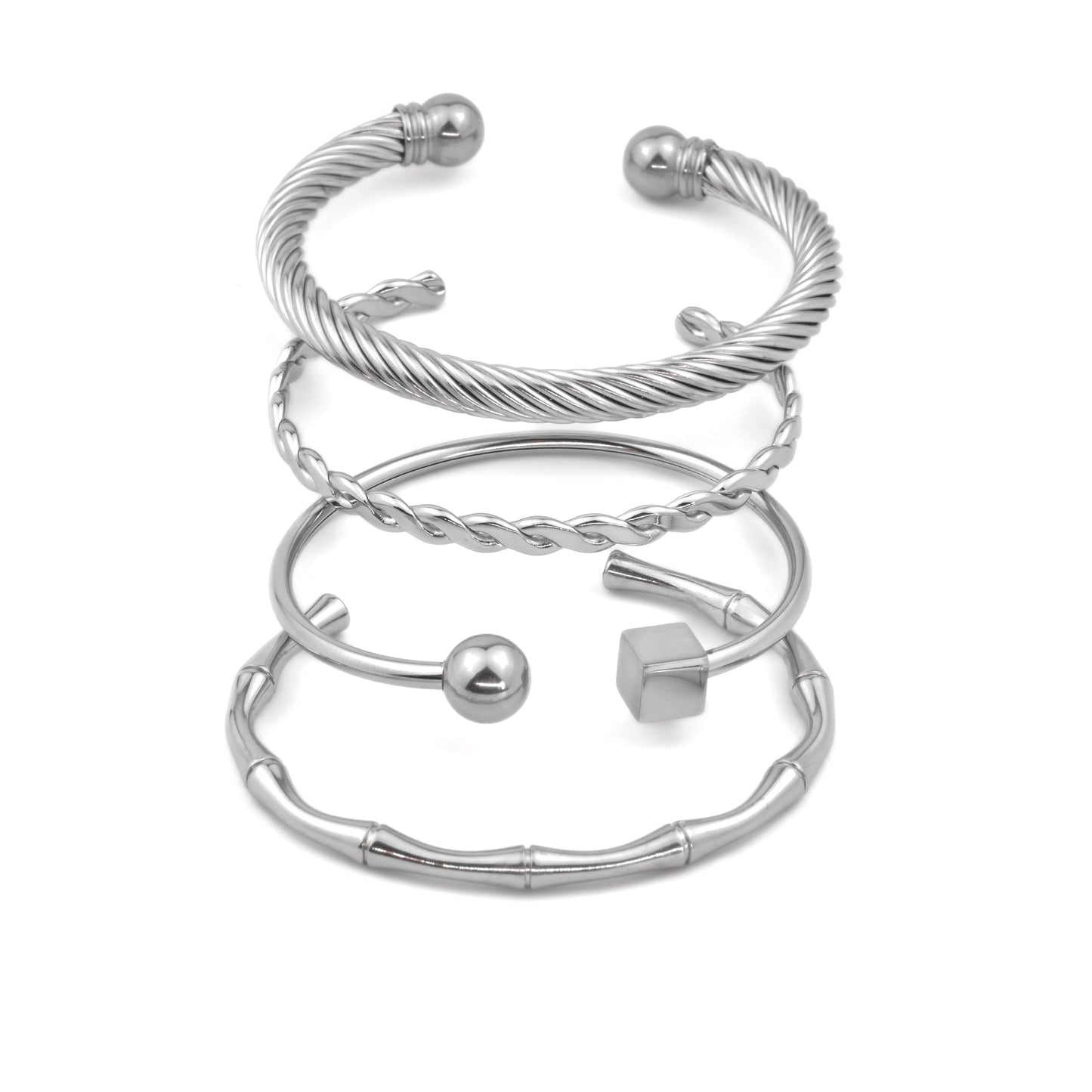 Set of silver cuff bracelets on a white background