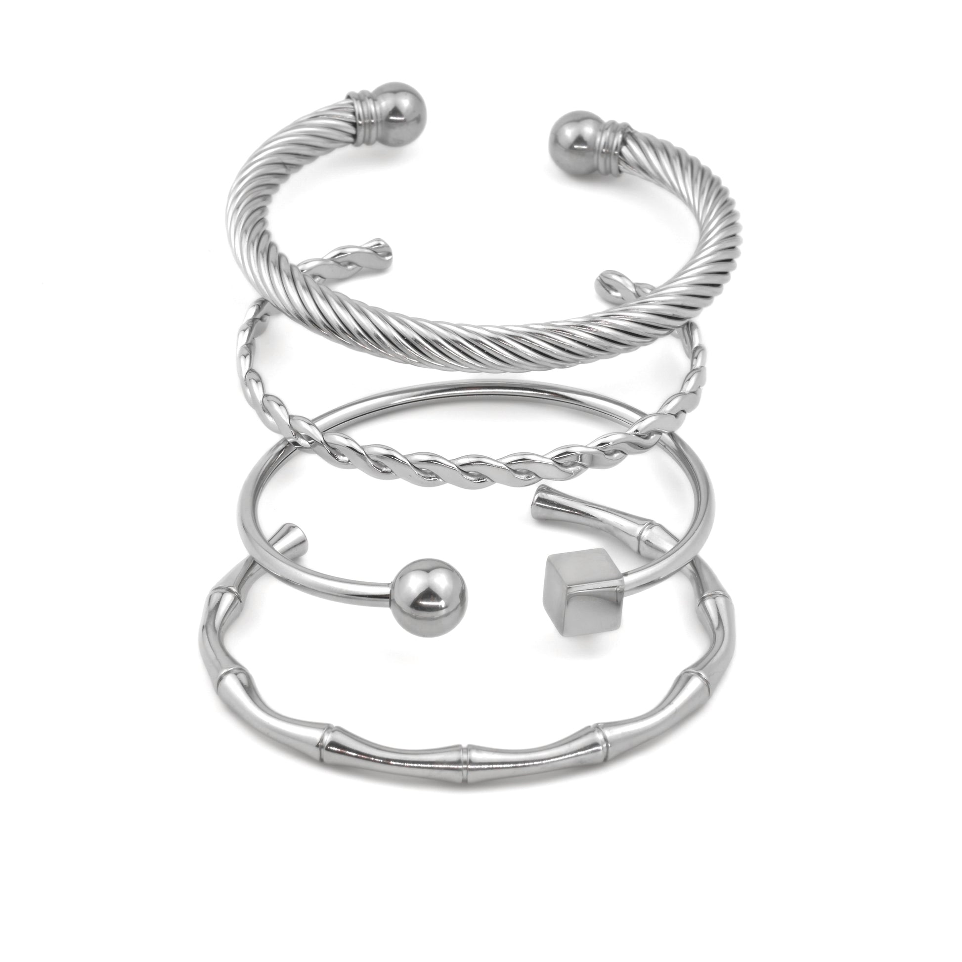 Set of silver cuff bracelets on a white background