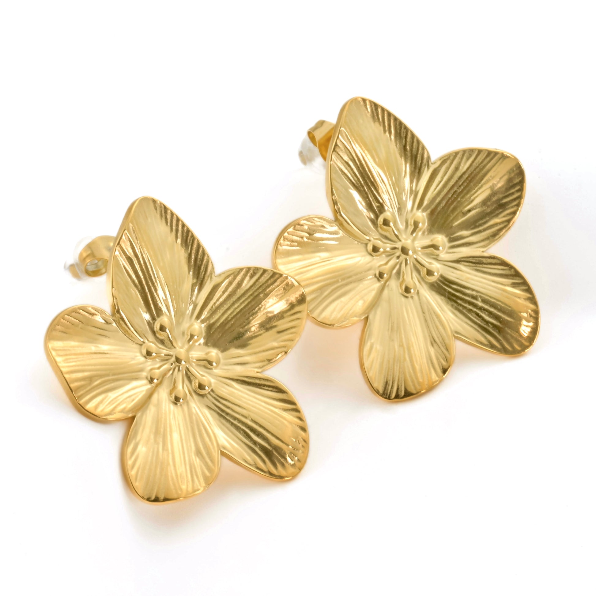 Gold flower-shaped earrings on a white background