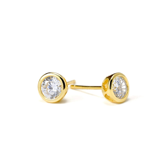 Gold CZ stud earrings with heart cut-outs and clear gemstones on a white background