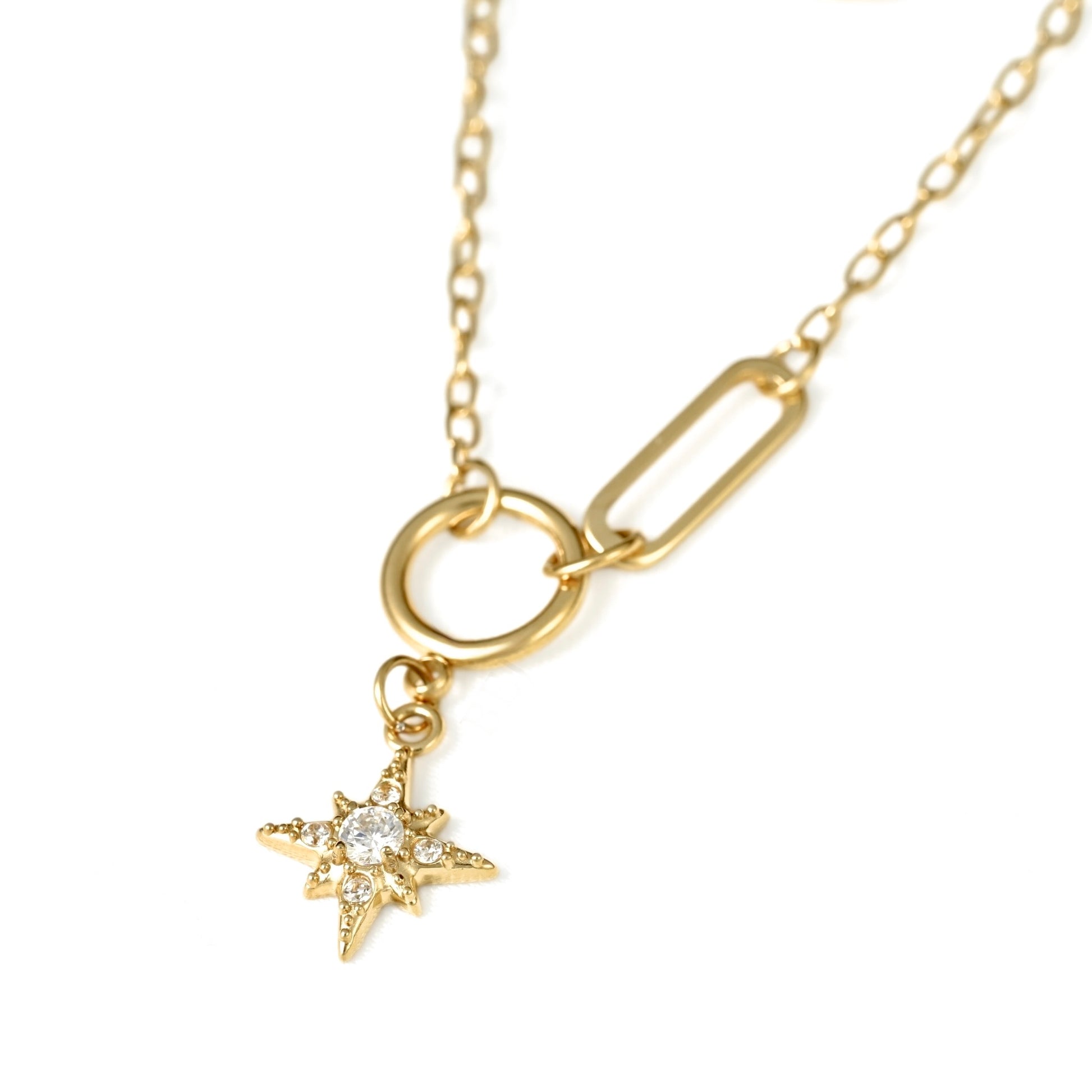 A gold-toned chain necklace featuring a toggle ring closure, a rectangular link accent, and a dangling starburst charm set with small clear stones, shown on a plain white background.