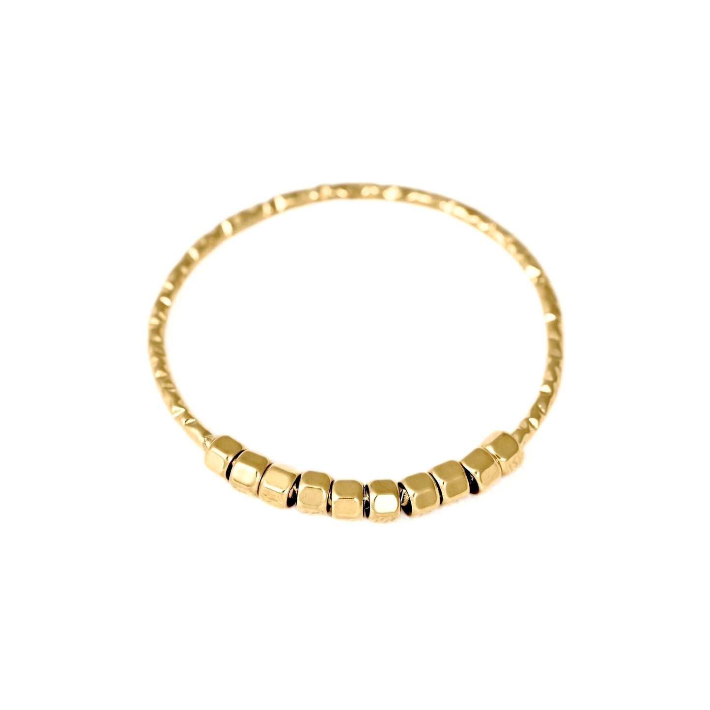 A gold beaded bracelet with a textured band and a row of small hexagonal beads at the front, shown on a plain white background.
