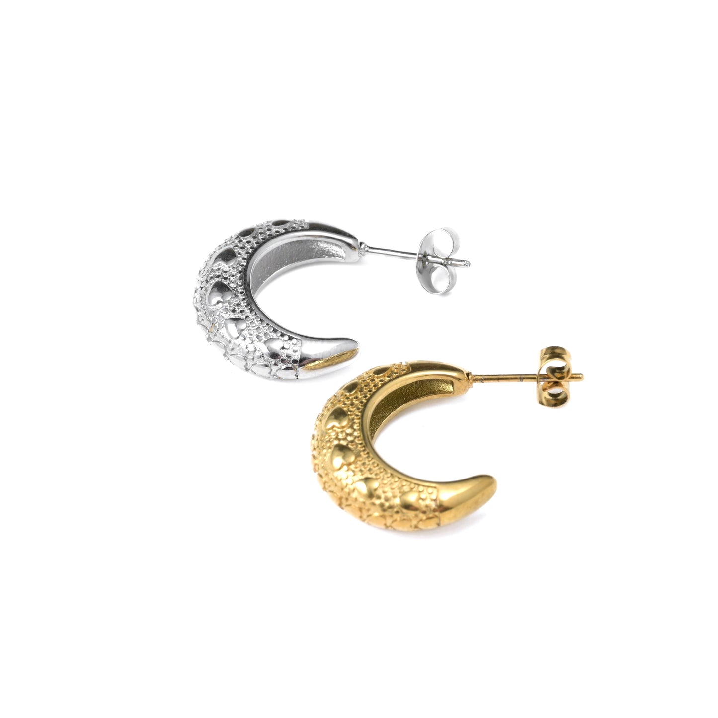 Pair of gold and silver crescent moon earrings  with heart details on a white background