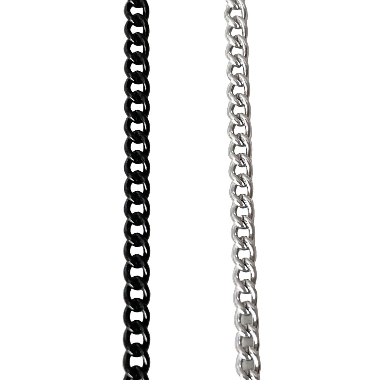 Close-up top view of two curb chain necklaces, one black and one silver, on a white background.