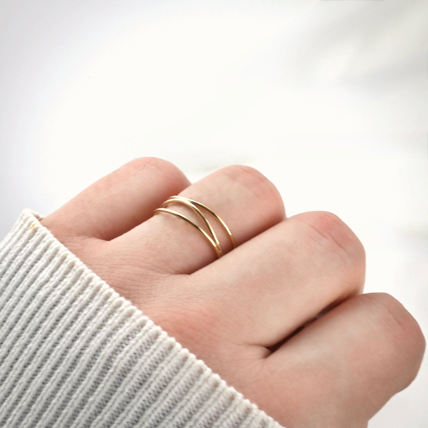 Gold ring on a finger  with a fist pose against a white background