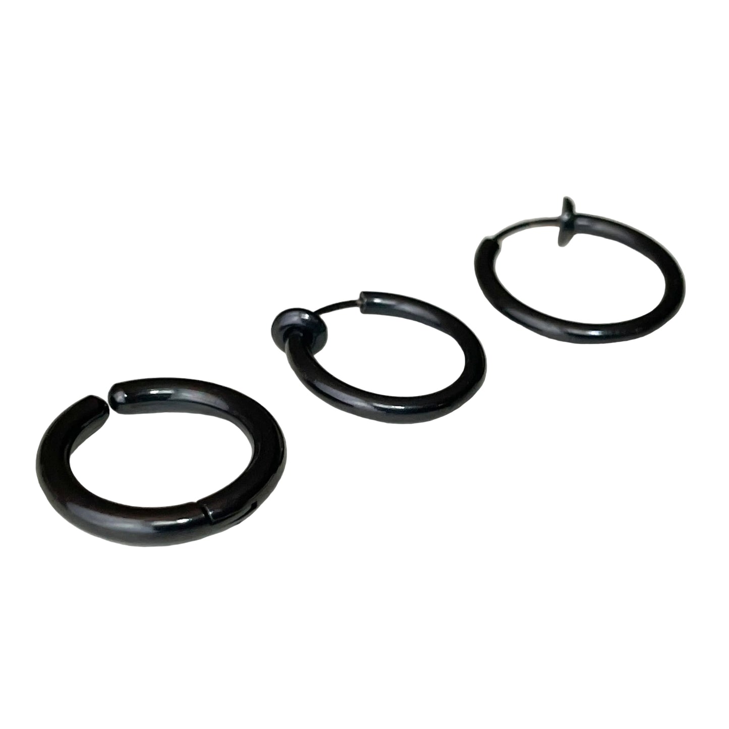 Set of three black fake hoop earrings on a white background