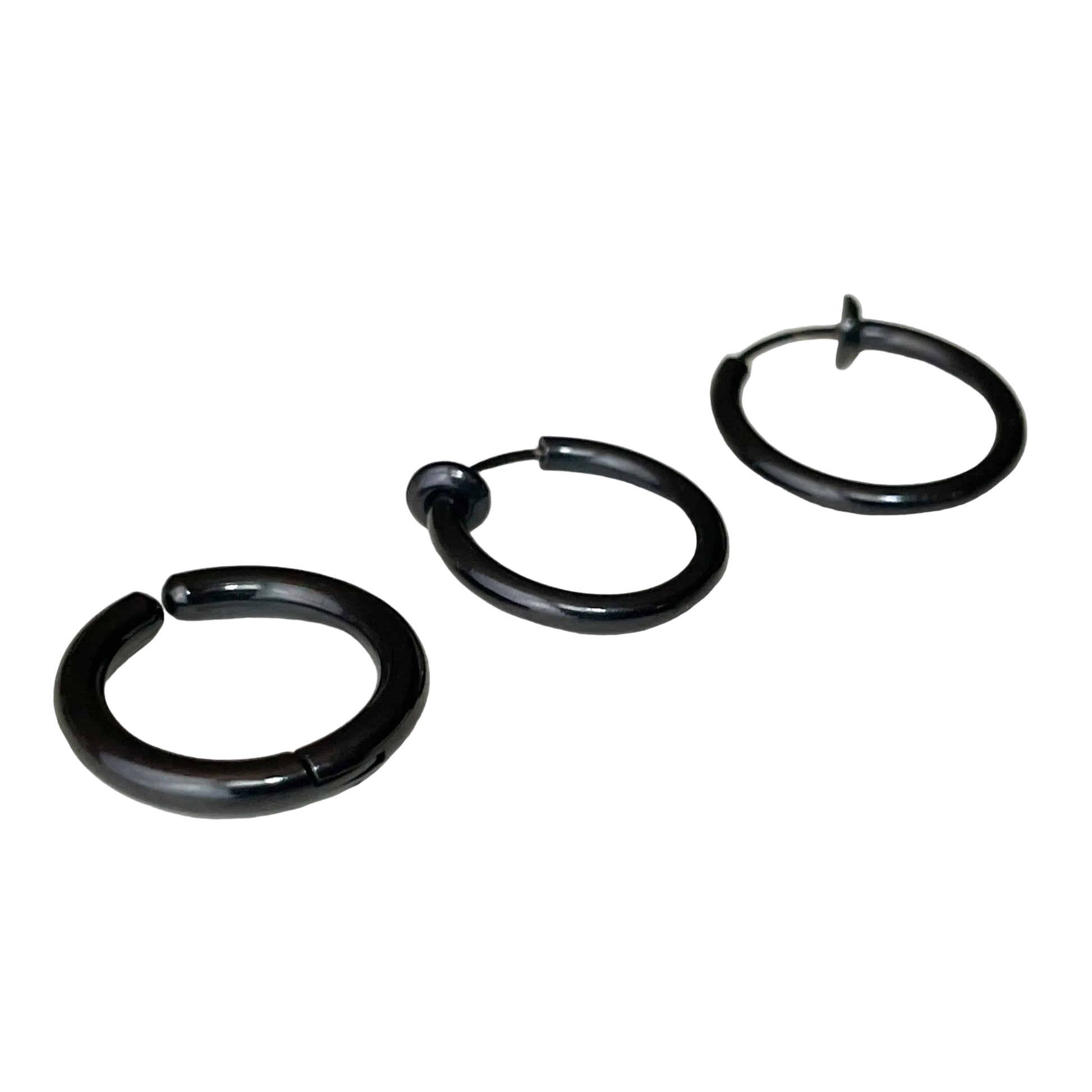 Set of three black fake hoop earrings on a white background