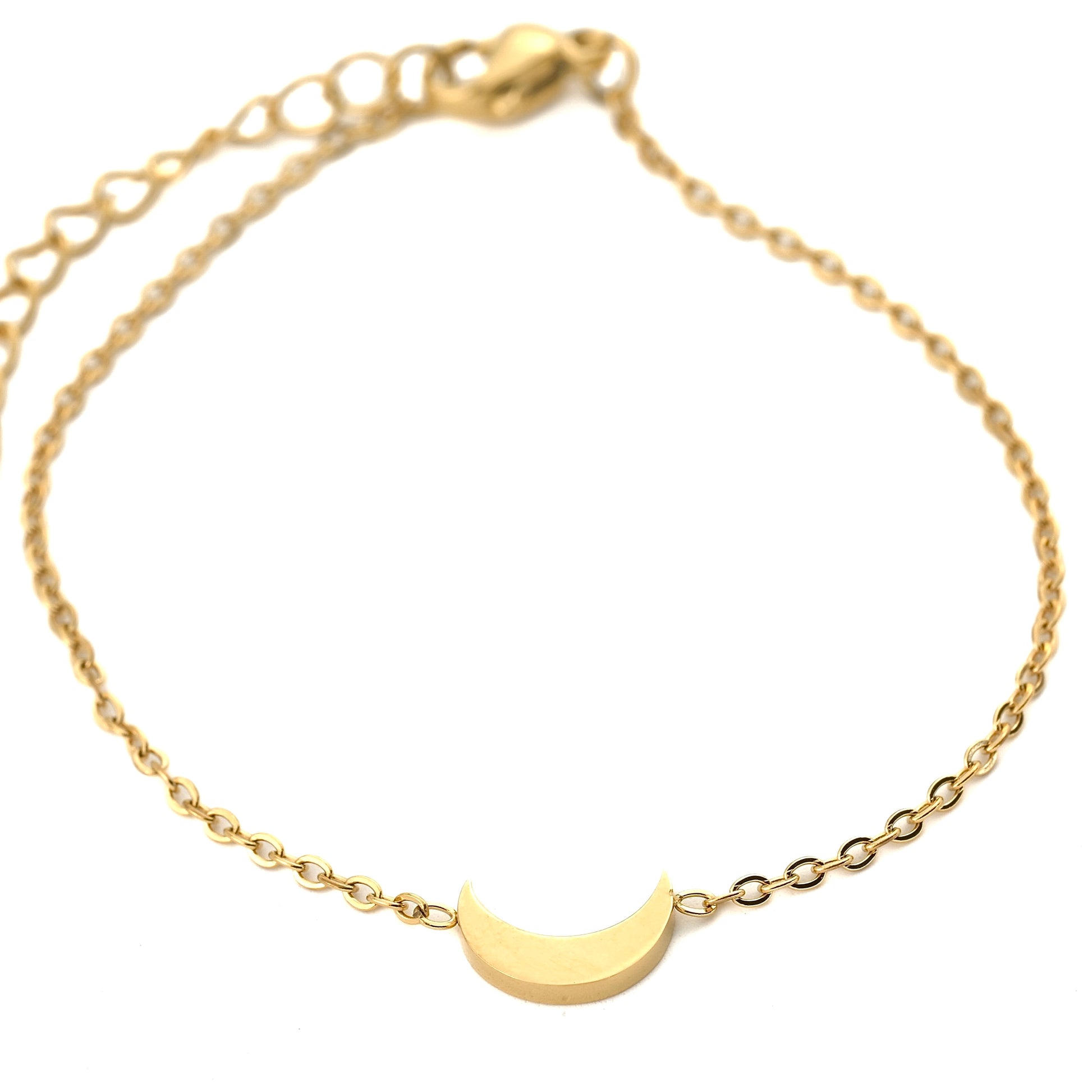 Gold bracelet with a crescent moon charm on a white background