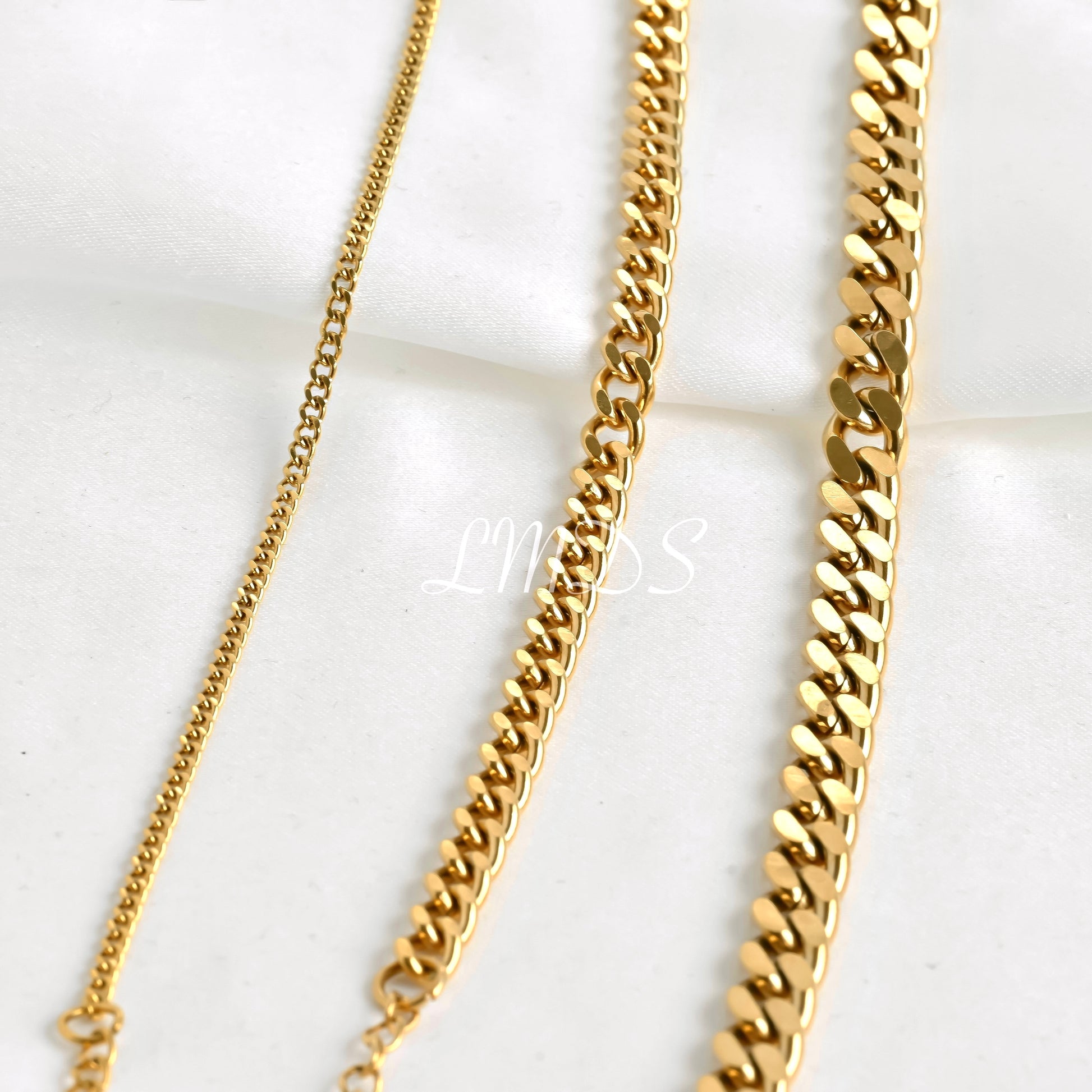 2mm, 5mm and 7mm gold curb chain  bracelets on a white background