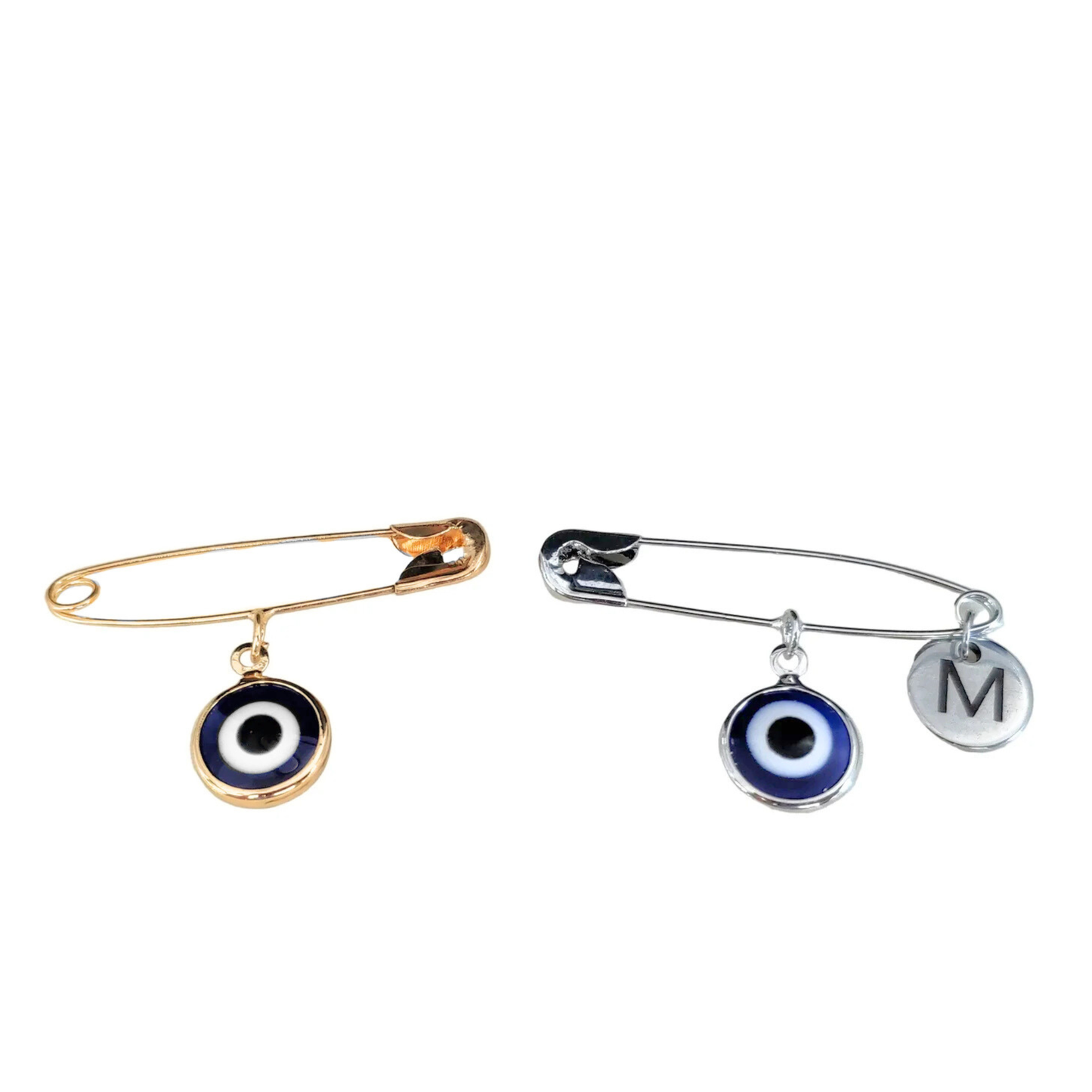 Two brooches with eye-shaped charms on a white background