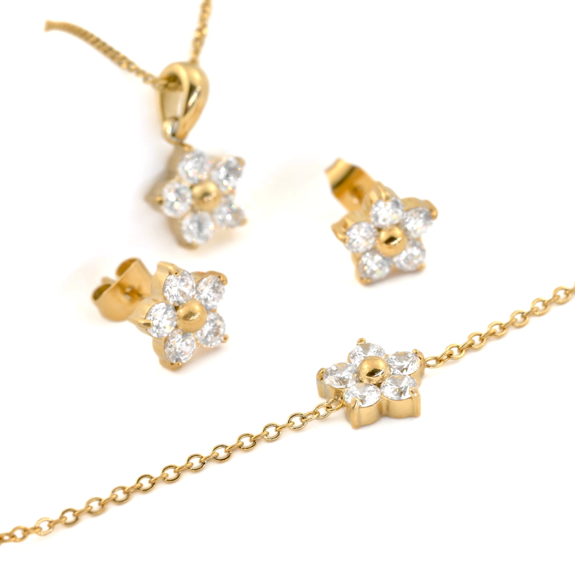 Gold flower jewelry set with necklace, earrings, and bracelet on a white background