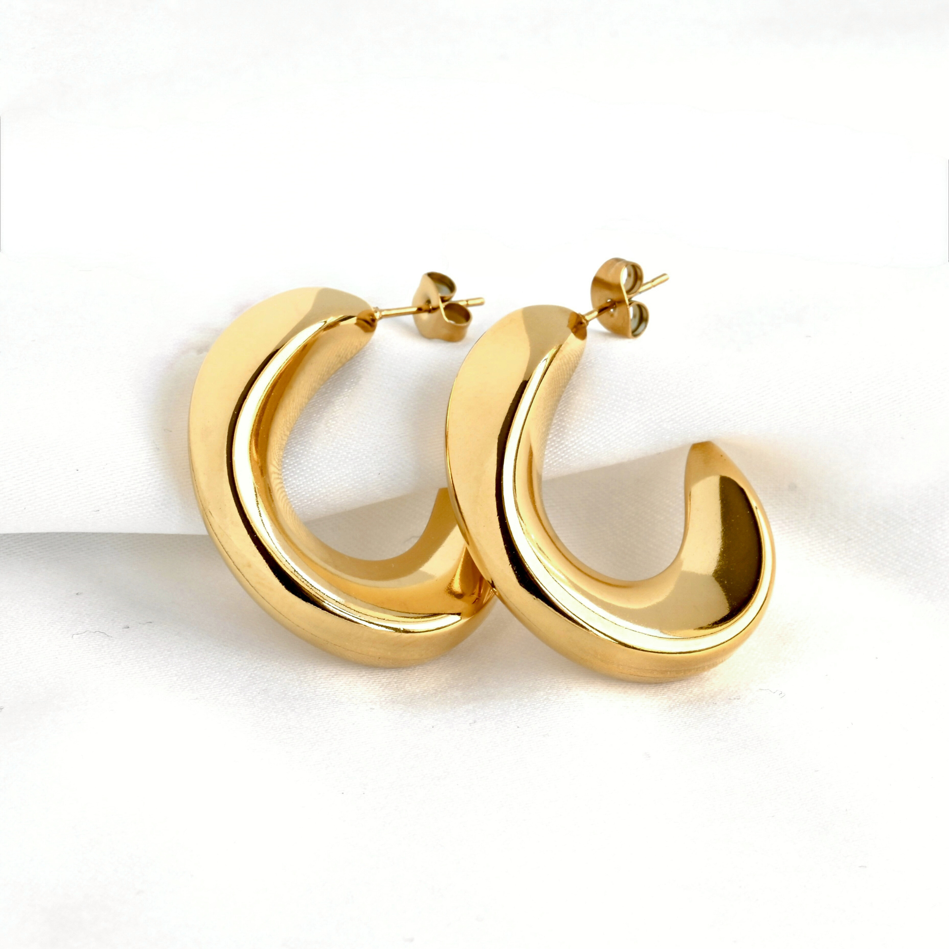 Gold hoop earrings on a white background