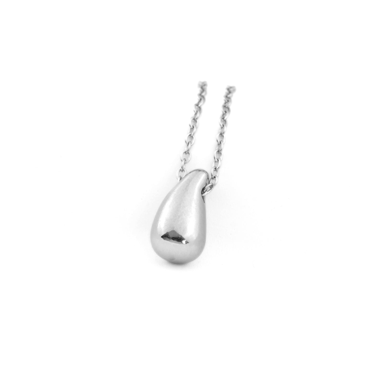 Silver teardrop pendant on a chain against a white background