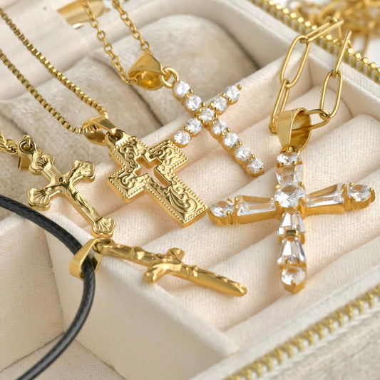 Personalized gold necklaces with cross pendants on a beige fabric background