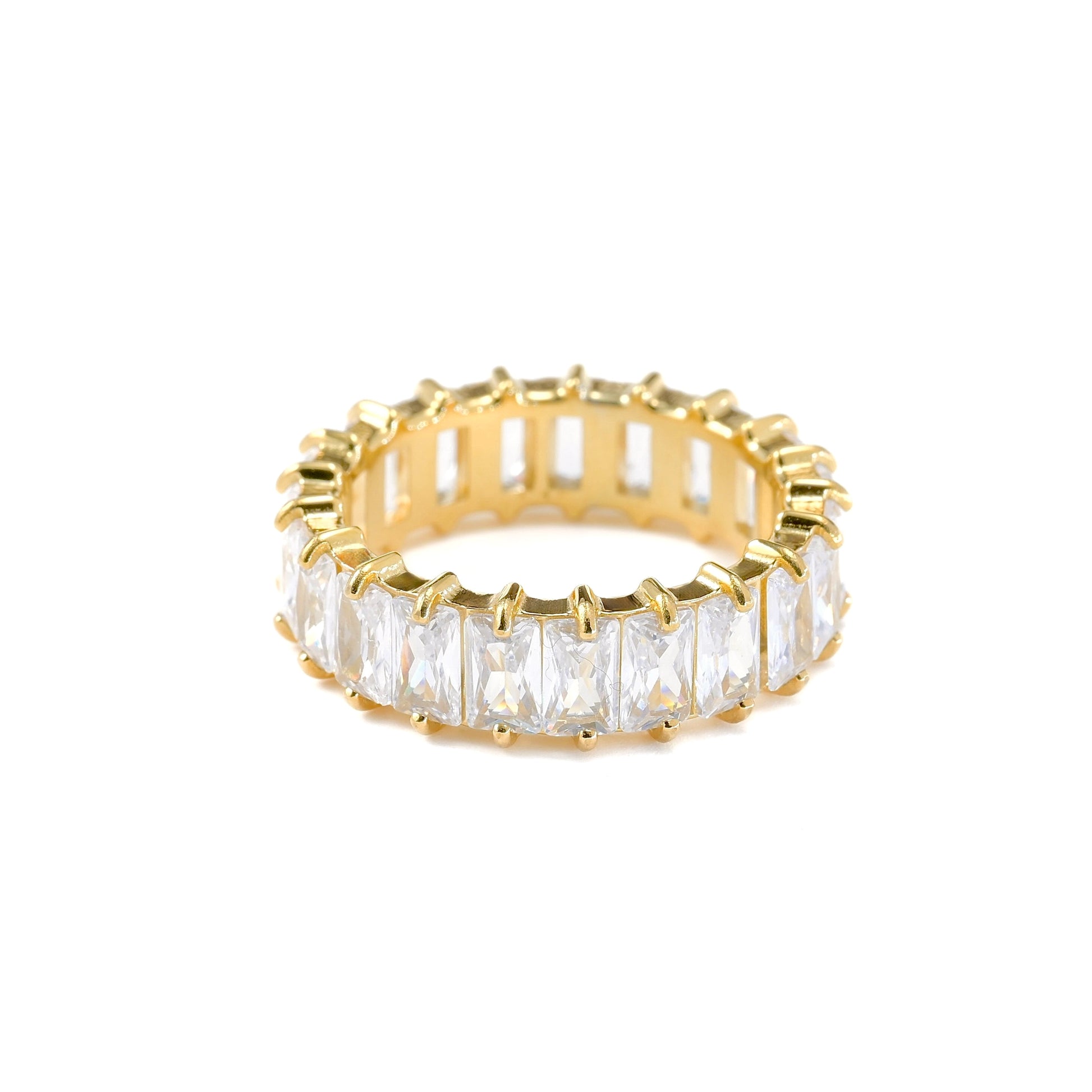 Gold ring with clear gemstones on a white background