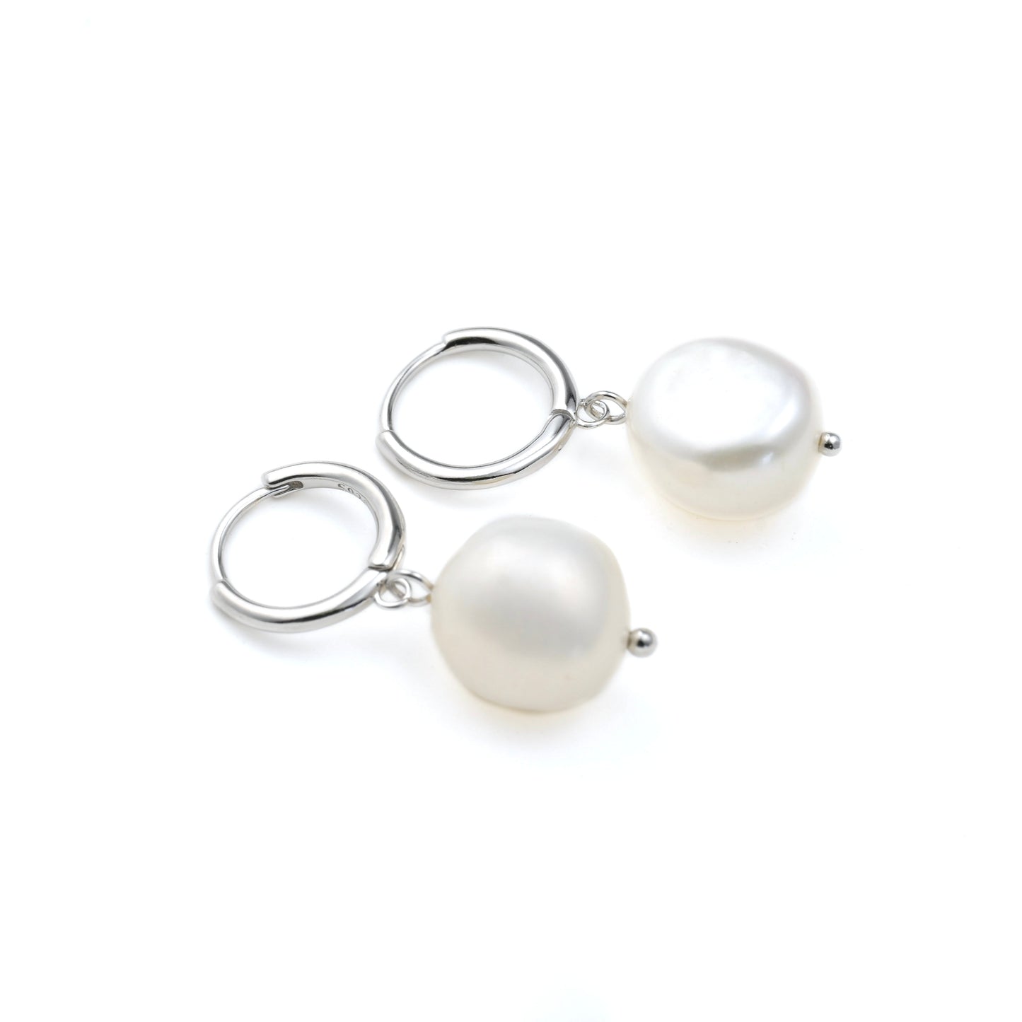 Pair of small silver  hoop earrings with freshwater pearl dangles  on a white background