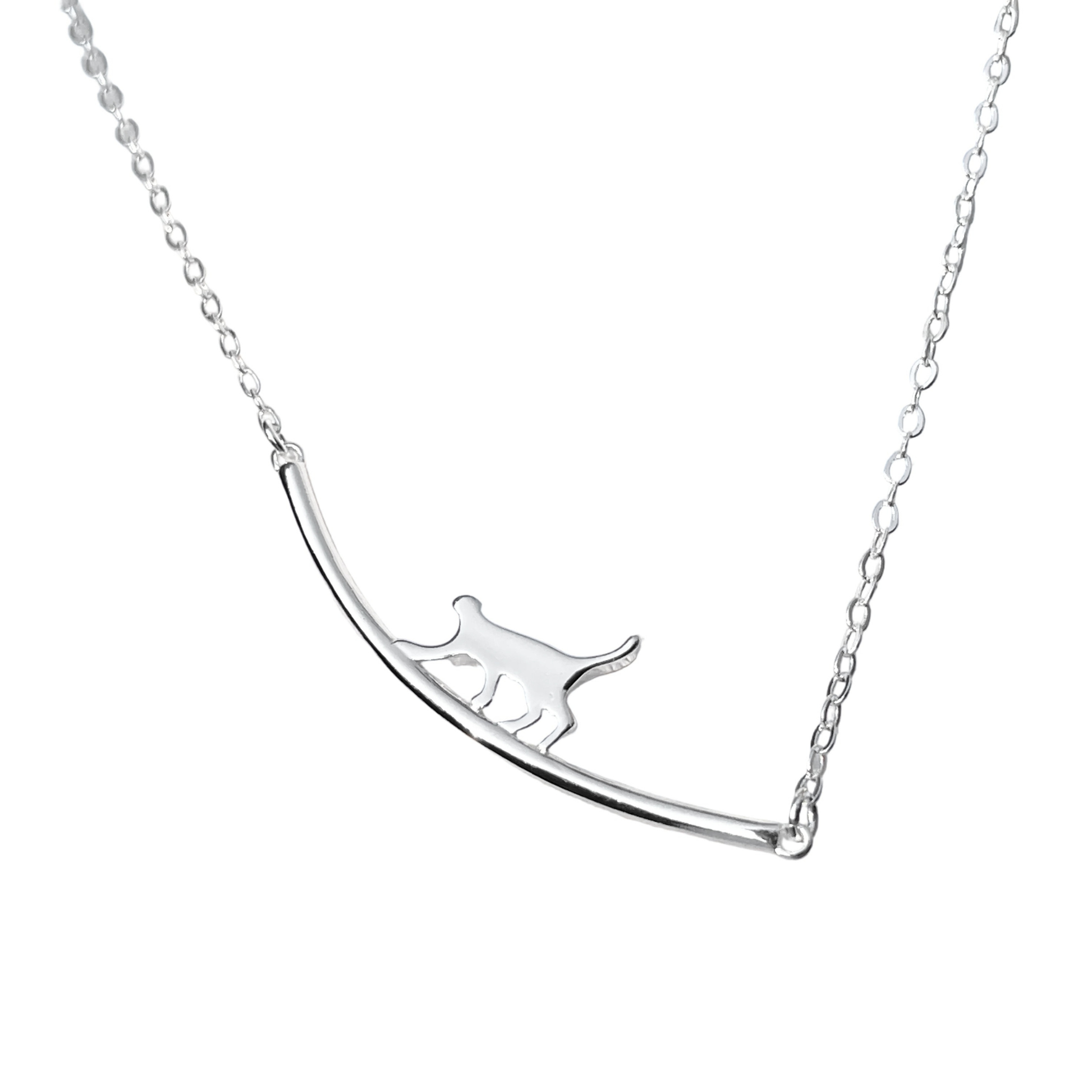 Silver necklace with curved bar cat pendant on a white background